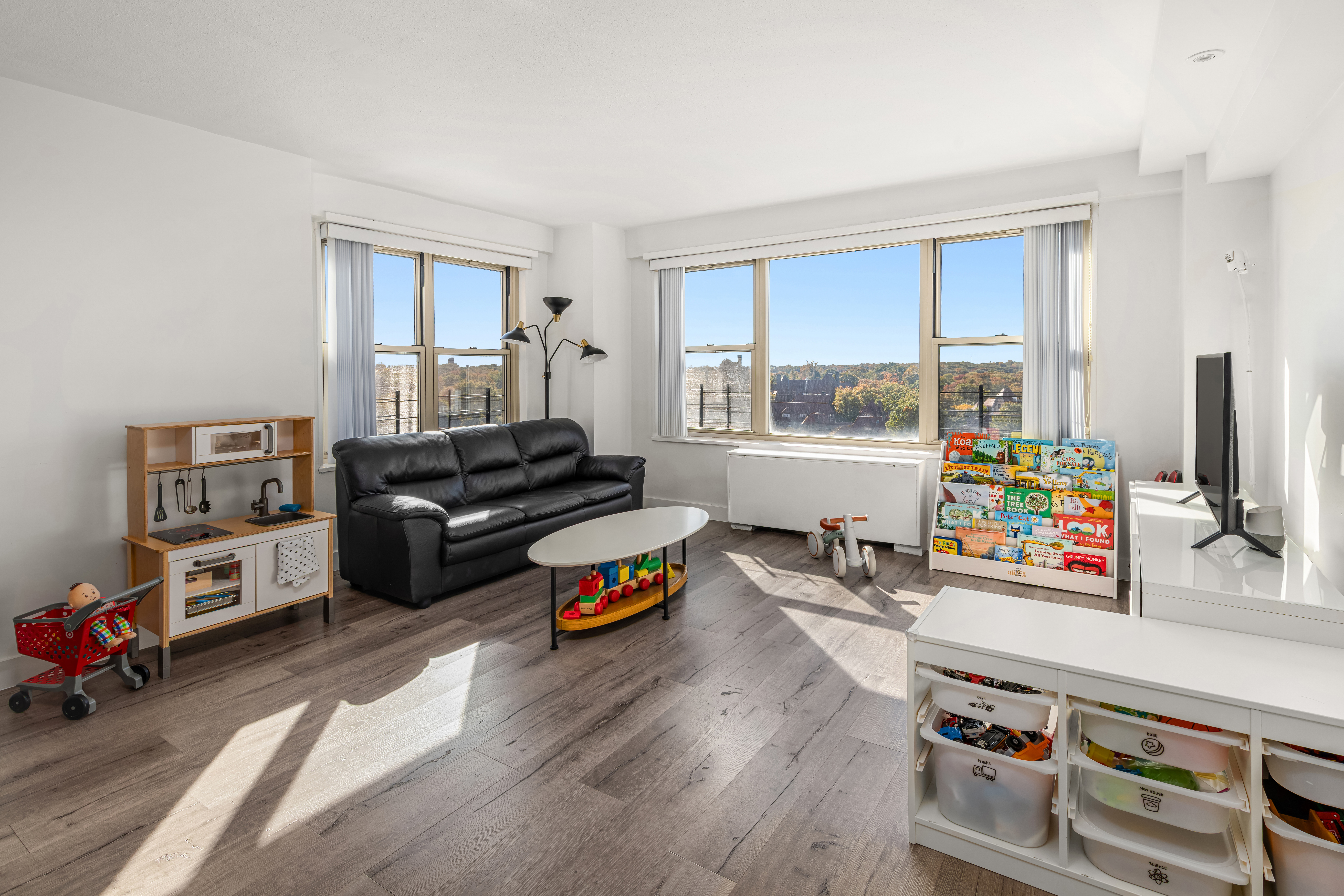 107-40 Queens Boulevard, Unit 11A Queens, NY 11375 - Photo 2 of 10 a living room with furniture and a flat screen tv