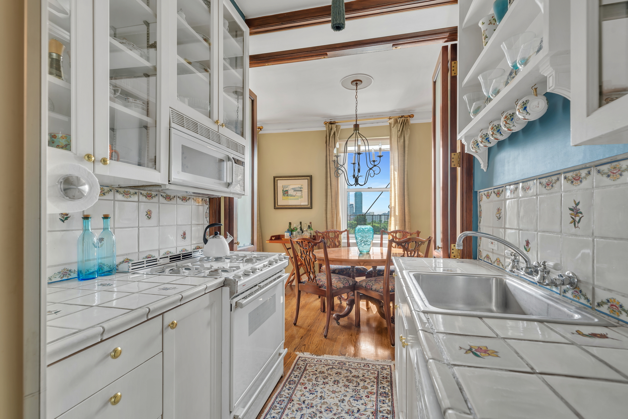 455 East 51st Street, Unit 6B Manhattan, NY 10022 - Photo 5 of 17 a kitchen with a sink stove and cabinets