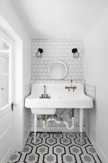 a bathroom with a sink toilet and mirror