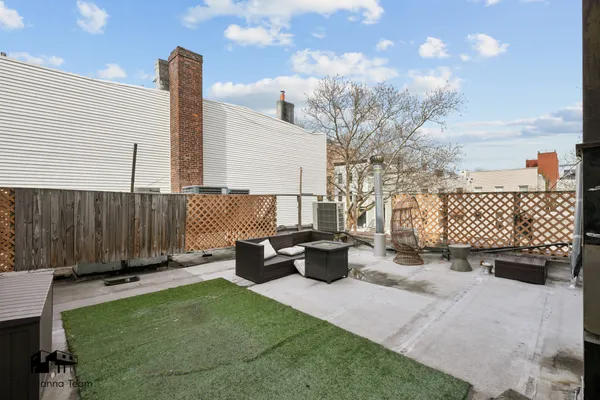 a view of a backyard with sitting area