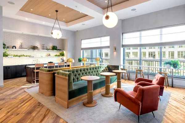 a living room with stainless steel appliances kitchen island granite countertop a large kitchen island a stove and a view of living room