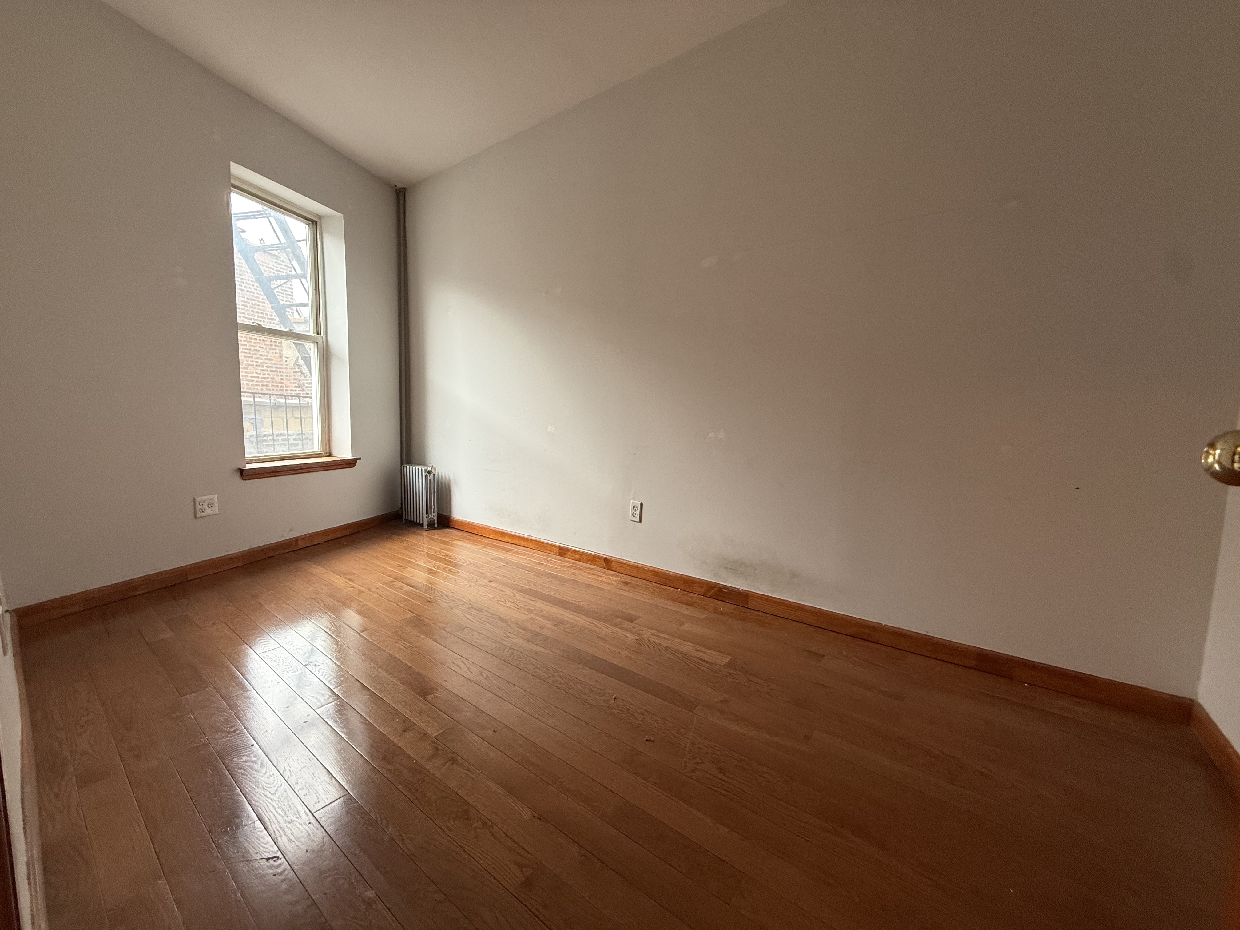 386 Prospect Place Brooklyn, NY 11238 - Photo 5 of 7 an empty room with wooden floor and windows