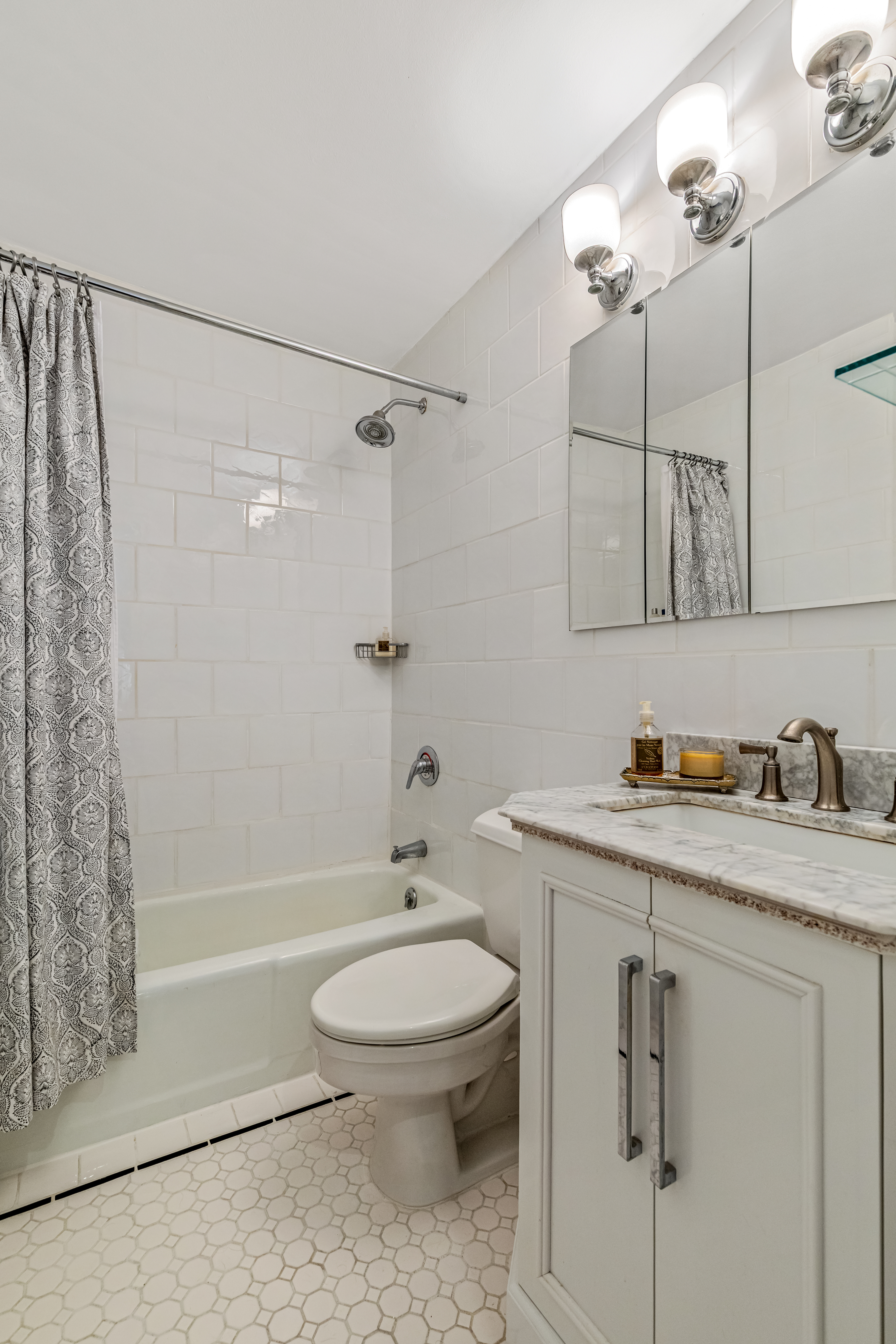 101 West 81st Street, Unit 601 Manhattan, NY 10024 - Photo 6 of 12 a bathroom with a granite countertop sink a toilet and shower