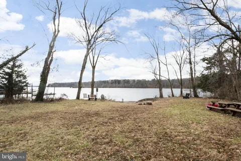 a view of car parked on street with large trees