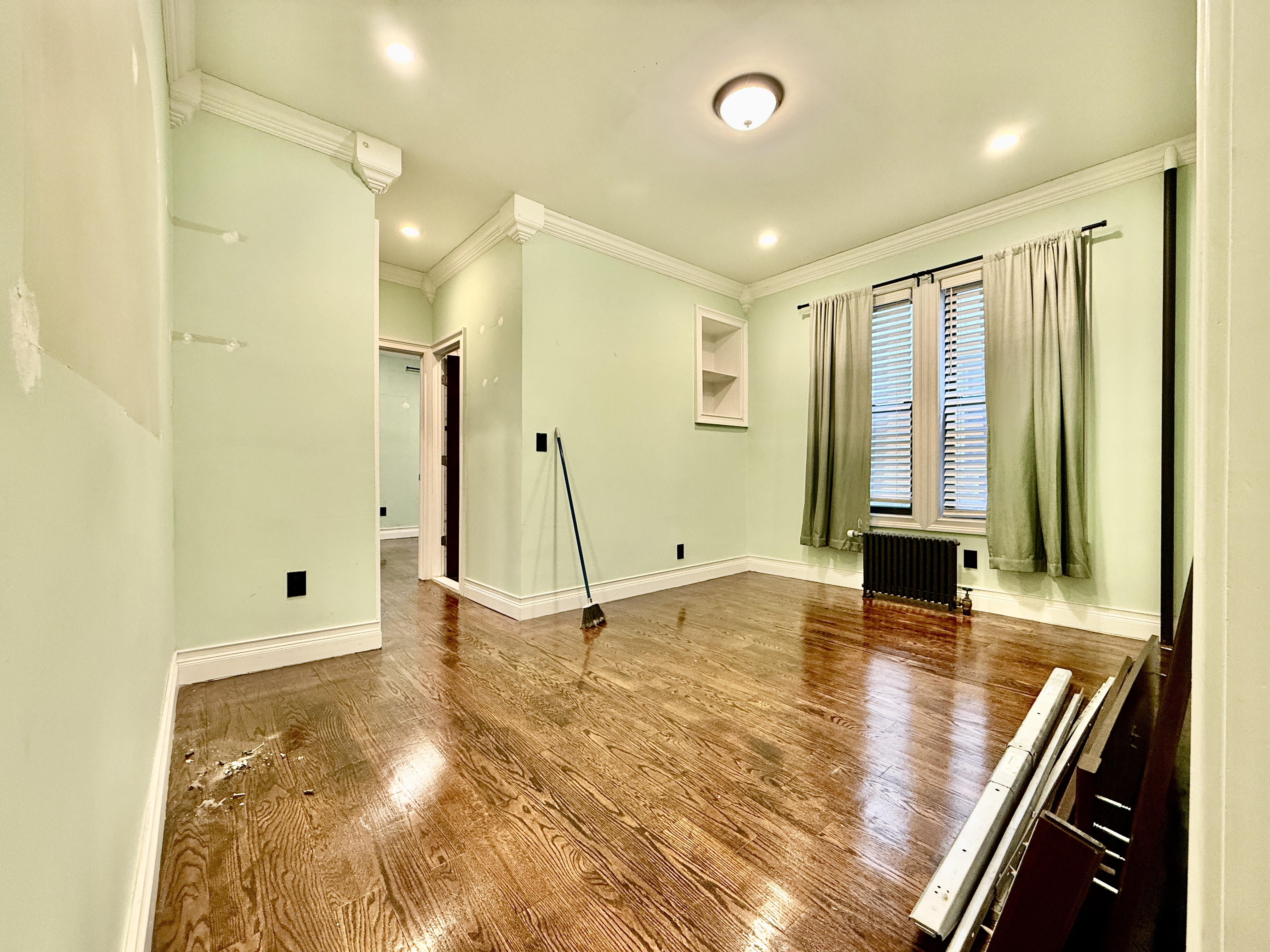 6817 Owls Head Court, Unit 1B Brooklyn, NY 11220 - Photo 2 of 6 a view of an empty room with window and a bathroom