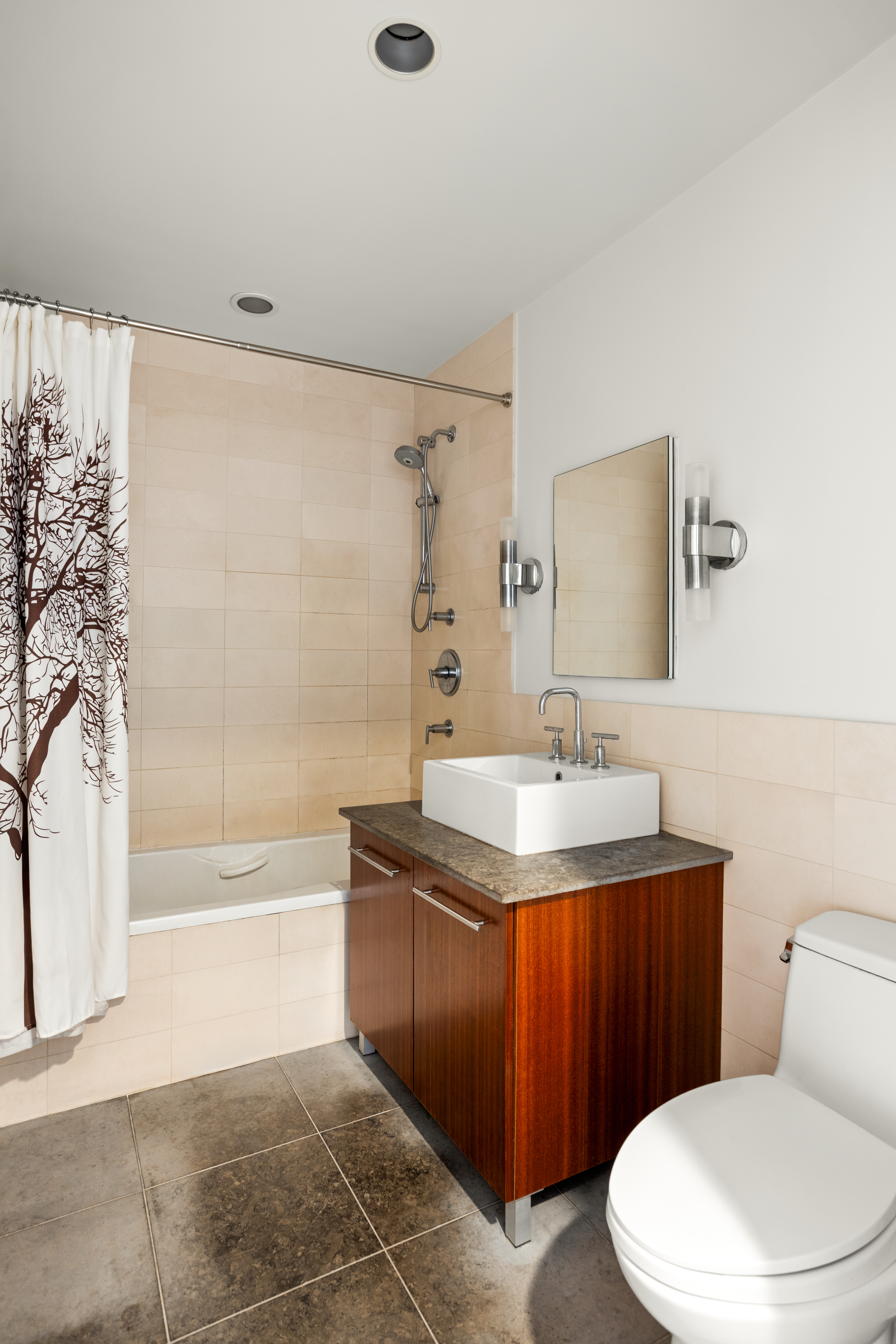 517 West 46th Street, Unit 205 Manhattan, NY 10036 - Photo 5 of 6 a bathroom with a sink a toilet and bathtub