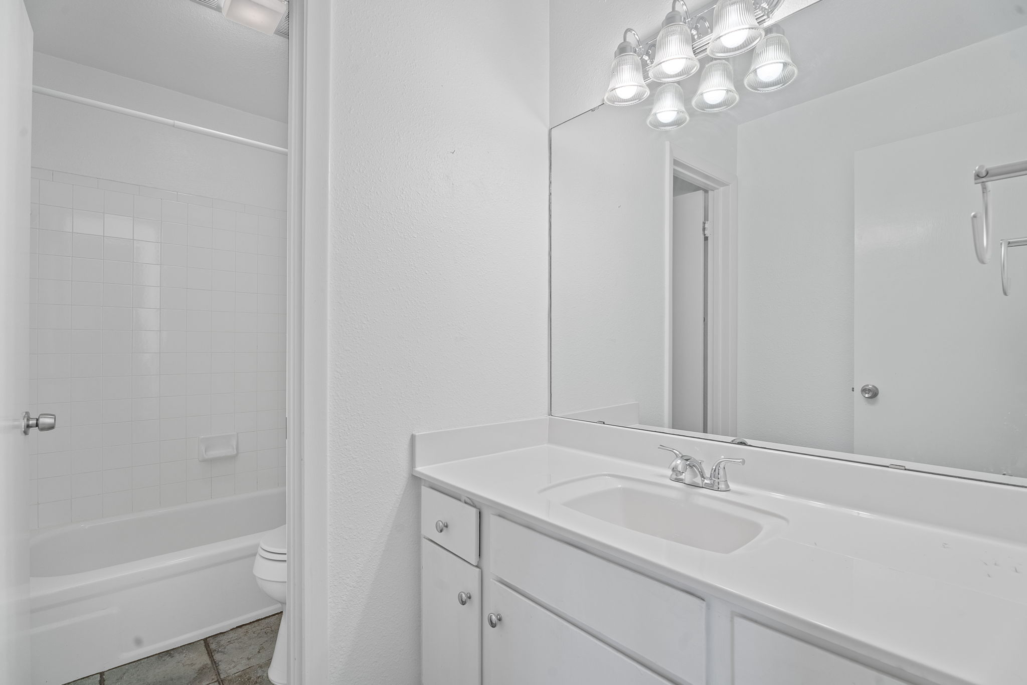 1510 West N Loop Boulevard, Unit 424 Austin, TX 78756 - Photo 23 of 25 a bathroom with a sink a large mirror and a bathtub