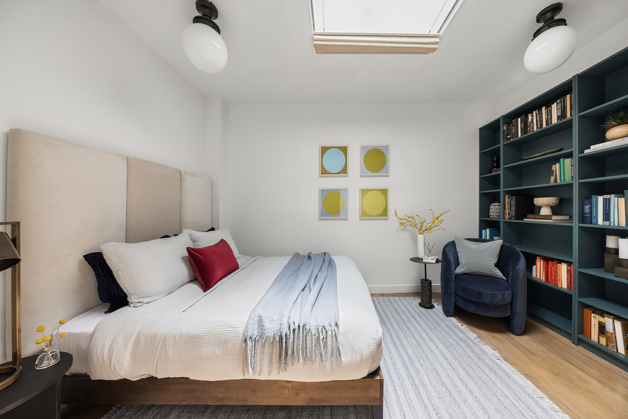 8 Charles Lane, Unit C Manhattan, NY 10014 - Photo 15 of 20 a bedroom with a bed and a bookshelf