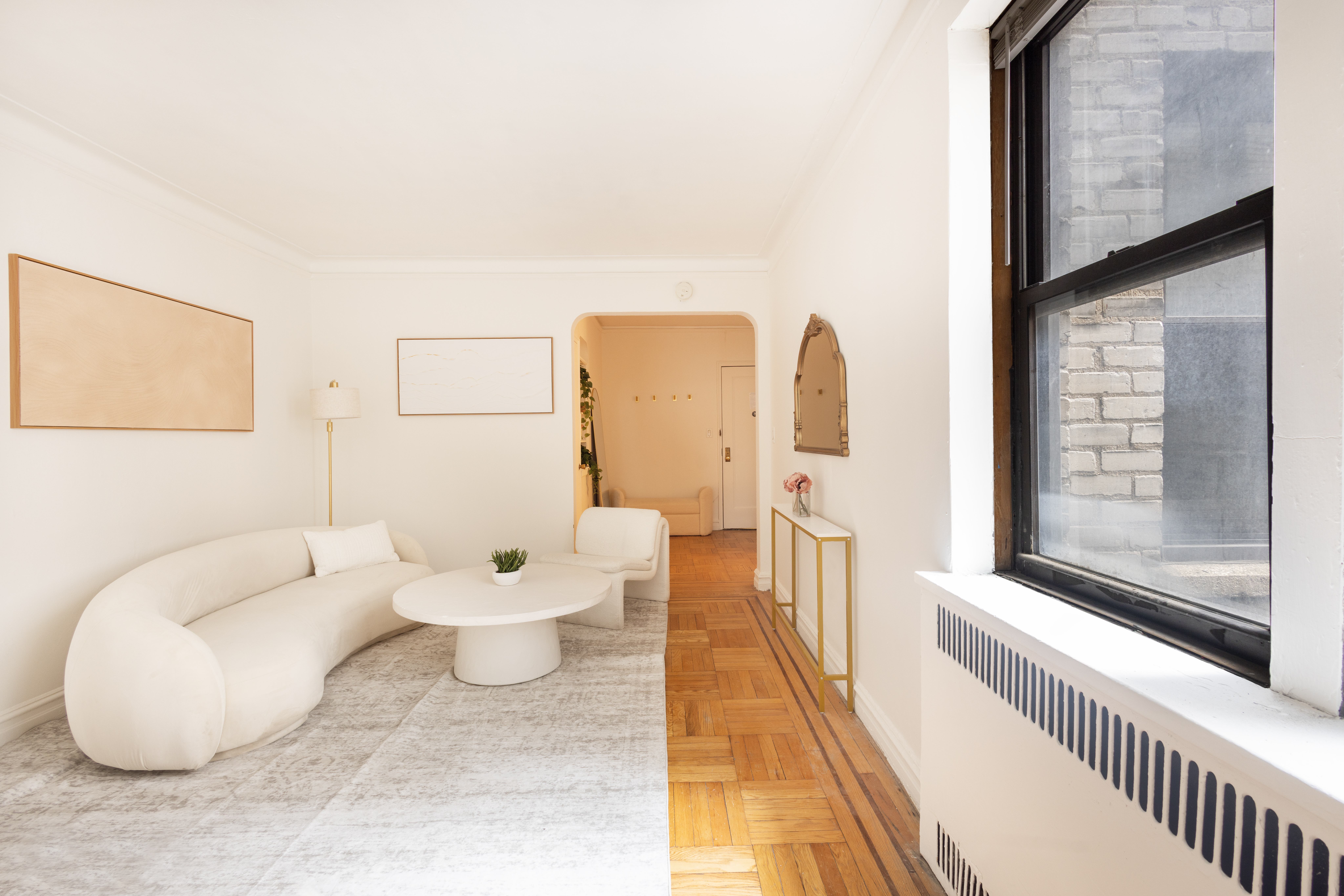 303 East 37th Street, Unit 3A Manhattan, NY 10016 - Photo 4 of 11 a living room with furniture and white walls