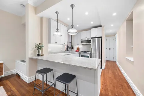 a large kitchen with kitchen island a island in the center