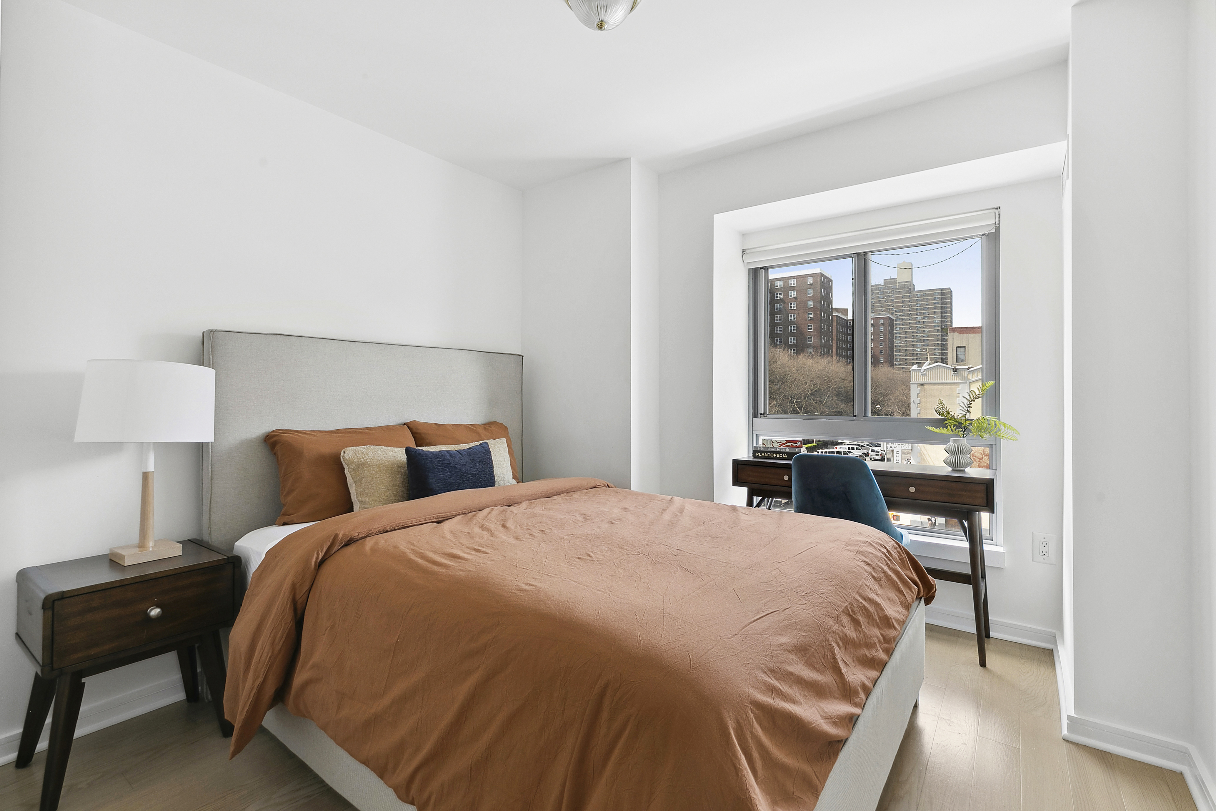 171 West 131st Street, Unit 407 Manhattan, NY 10027 - Photo 9 of 18 a bedroom with a bed and wooden floor