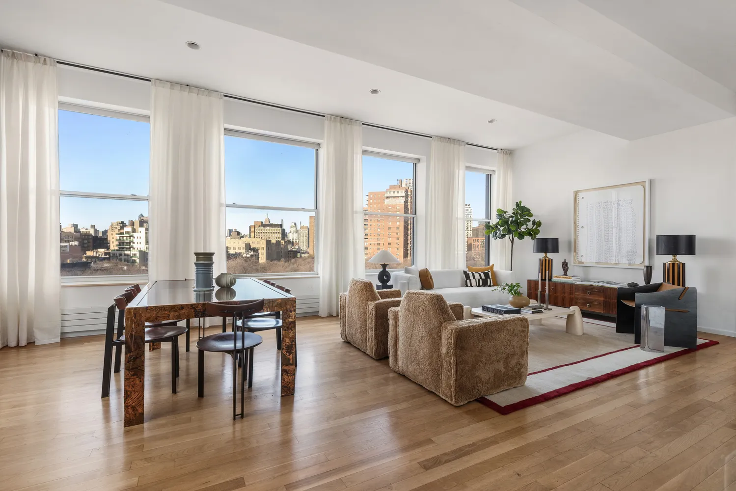 a living room with furniture wooden floor and a large window