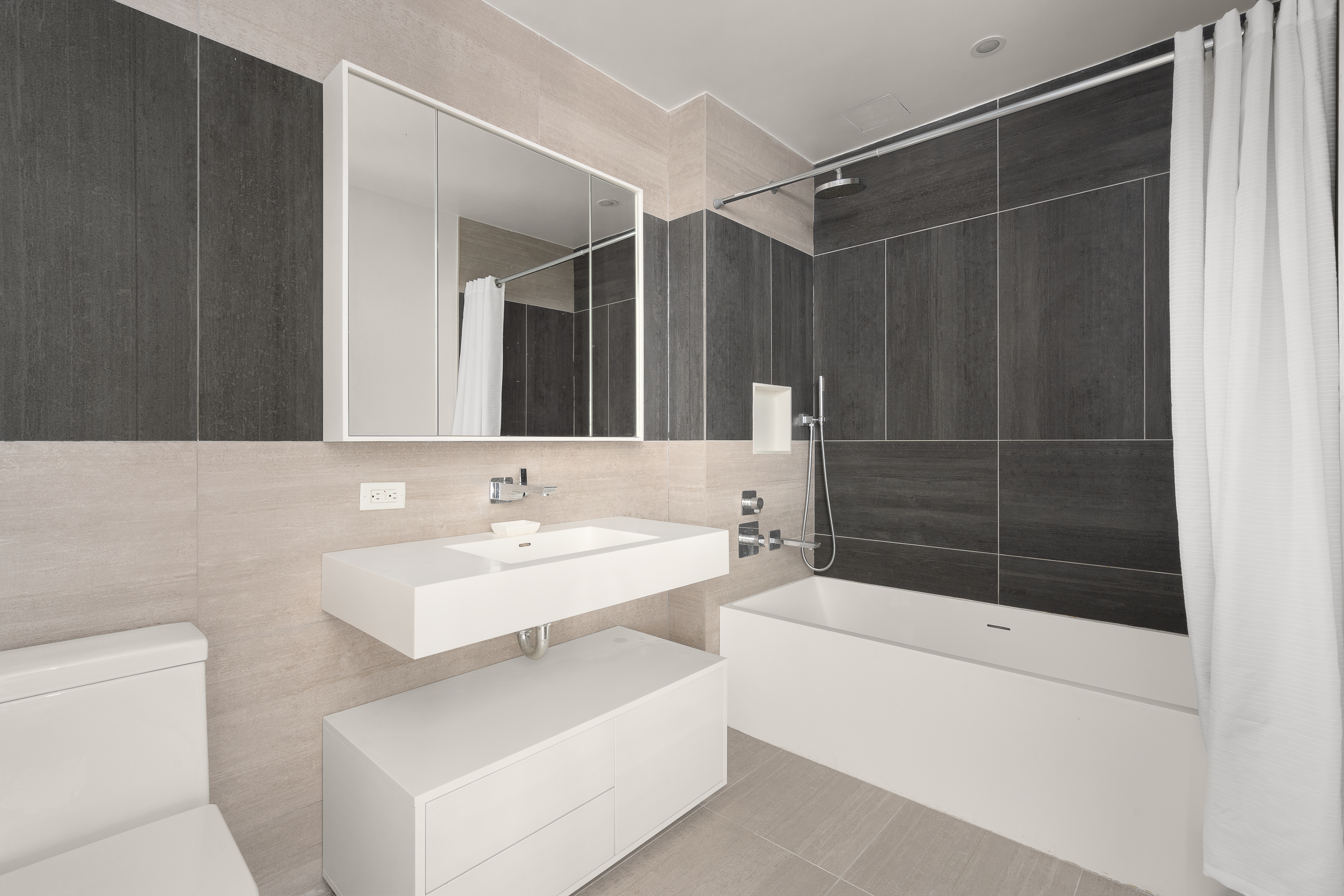 545 West 48th Street, Unit 308S Manhattan, NY 10036 - Photo 7 of 8 a bathroom with a sink a toilet a mirror and shower