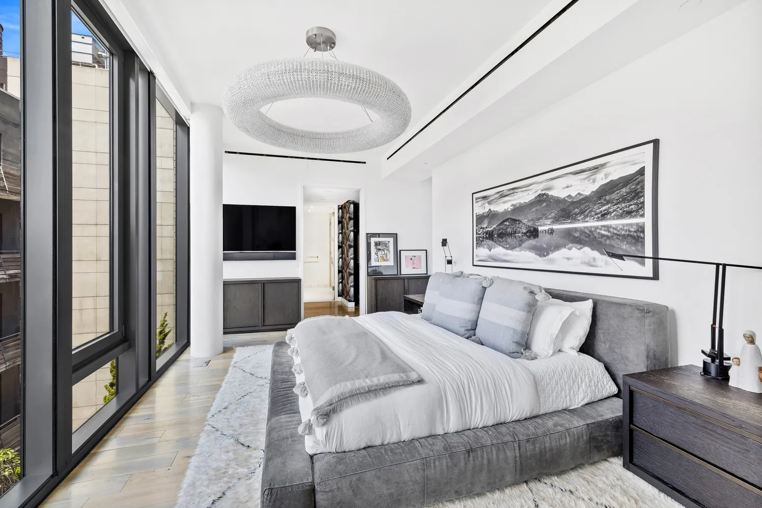 a bedroom with a large bed and a flat screen tv