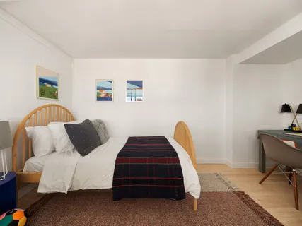 a bedroom with a bed and a chair