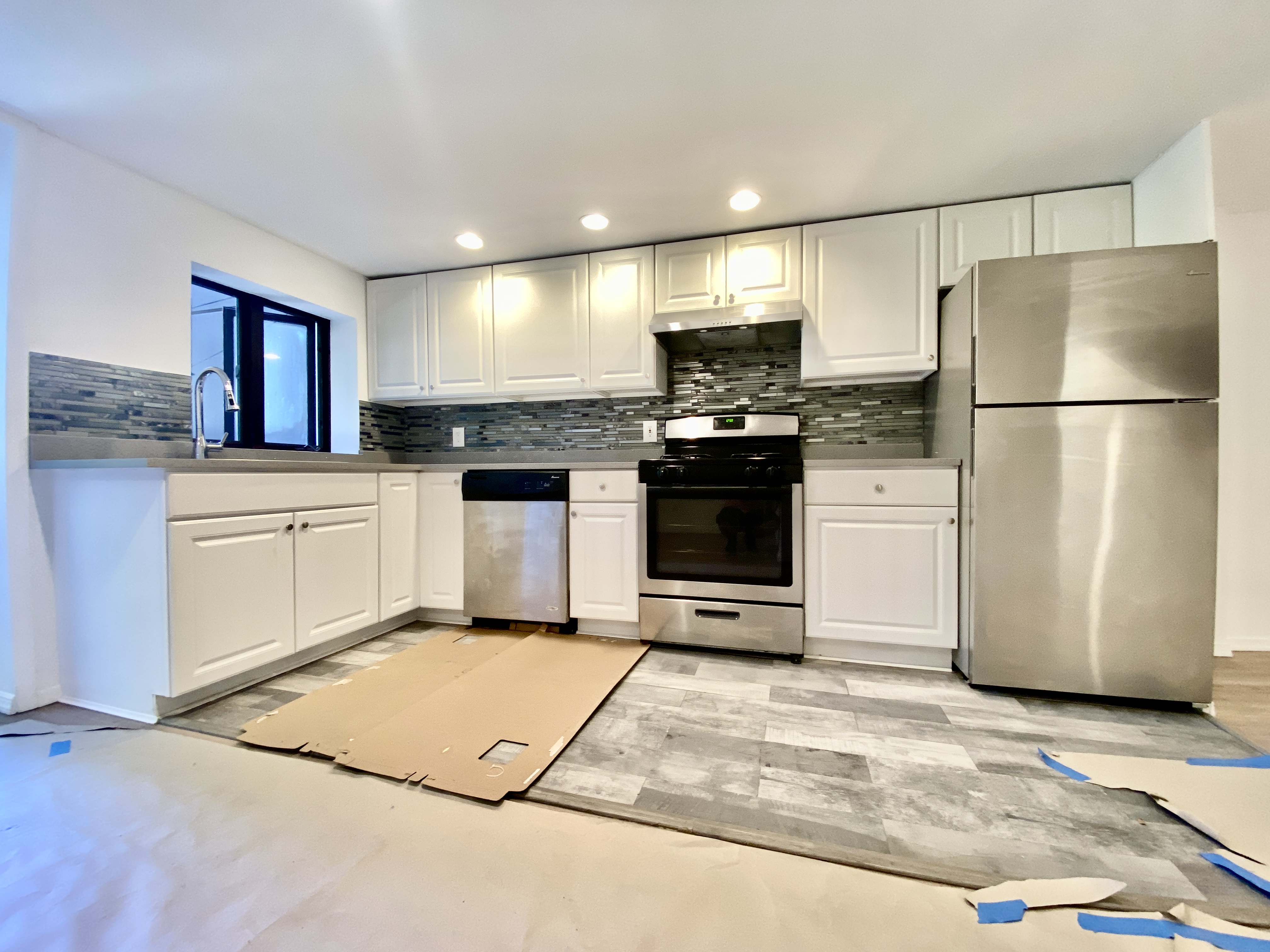 447 Degraw Street, Unit 1 Brooklyn, NY 11217 - Photo 5 of 11 a kitchen with stainless steel appliances kitchen island granite countertop a refrigerator sink and stove