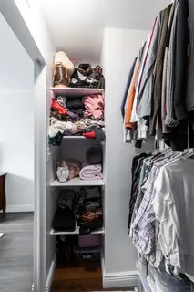 a view of walk in closet with clothes and shoes