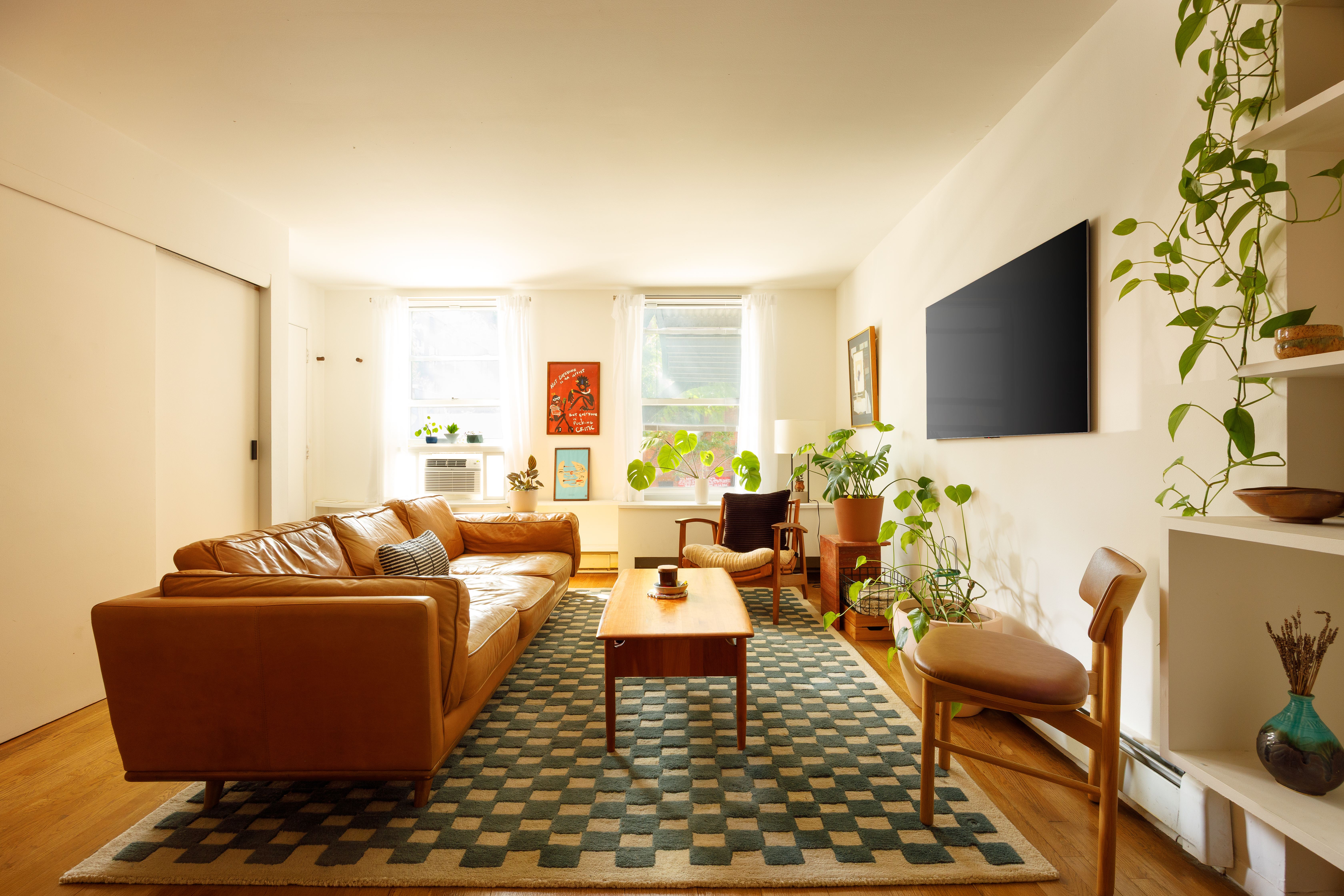 211 Berry Street, Unit 2 Brooklyn, NY 11249 - Photo 2 of 7 a living room with furniture and a flat screen tv