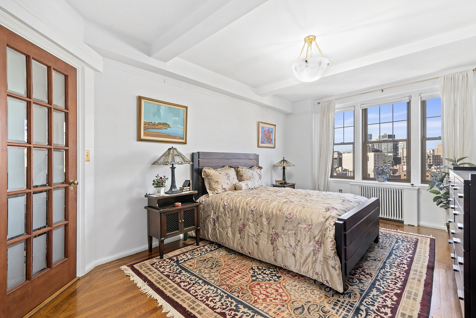 302 West 12th Street, Unit 12C Manhattan, NY 10014 - Photo 5 of 13 a bedroom with a bed and a window