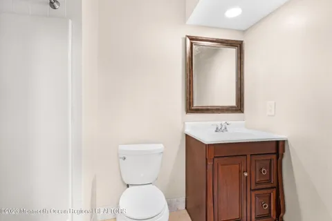 a bathroom with a toilet sink and mirror