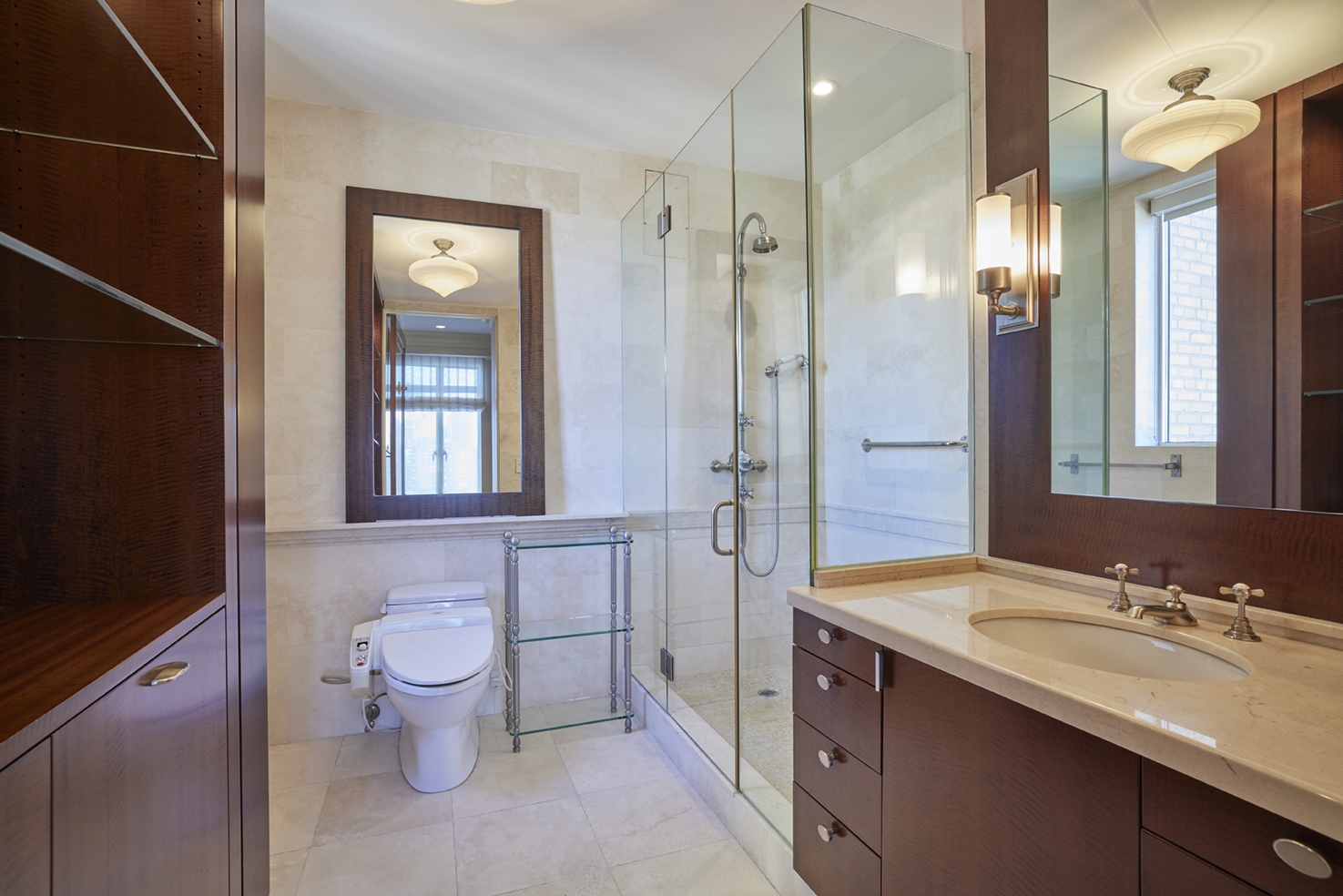115 Central Park West, Unit 18JK Manhattan, NY 10023 - Photo 11 of 25 a spacious bathroom with a granite countertop sink toilet a shower and a mirror