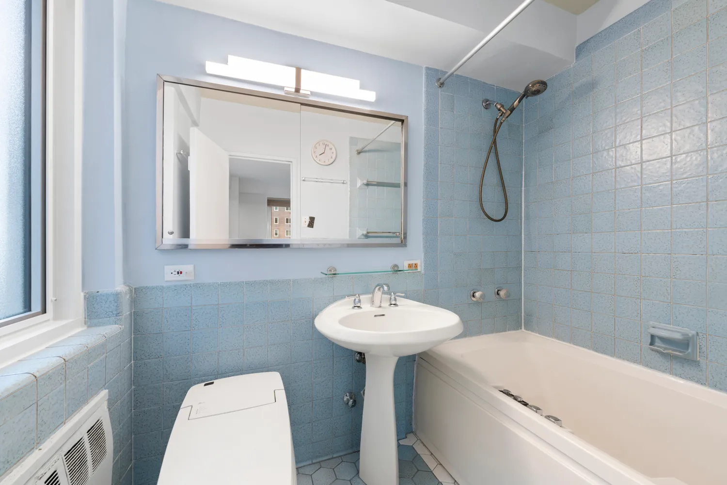 a bathroom with a sink a mirror toilet and bathtub