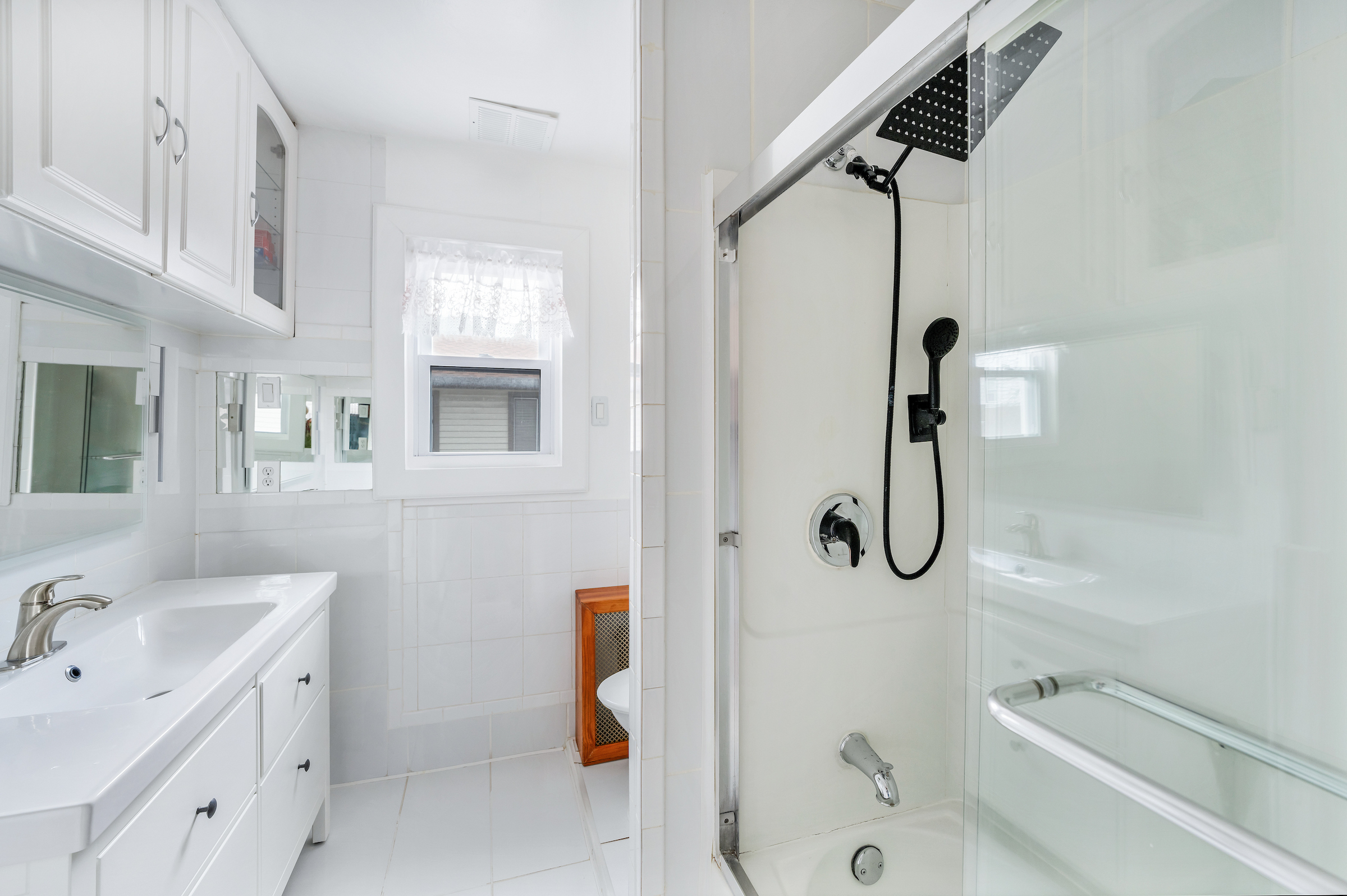 132-11 107th Avenue Queens, NY 11419 - Photo 9 of 14 a bathroom with a tub sink shower and mirror
