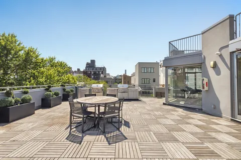 a view of a patio with a dining table and chairs with a patio