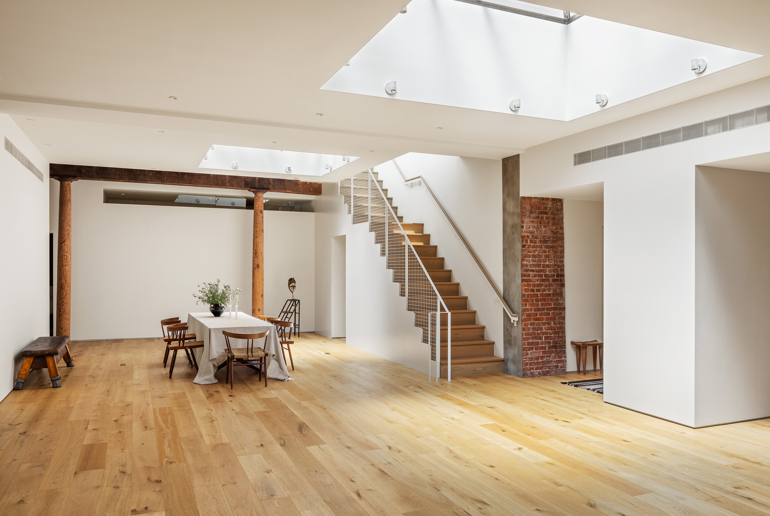477 Broome Street Manhattan, NY 10013 - Photo 1 of 18 a living room with furniture and stairs