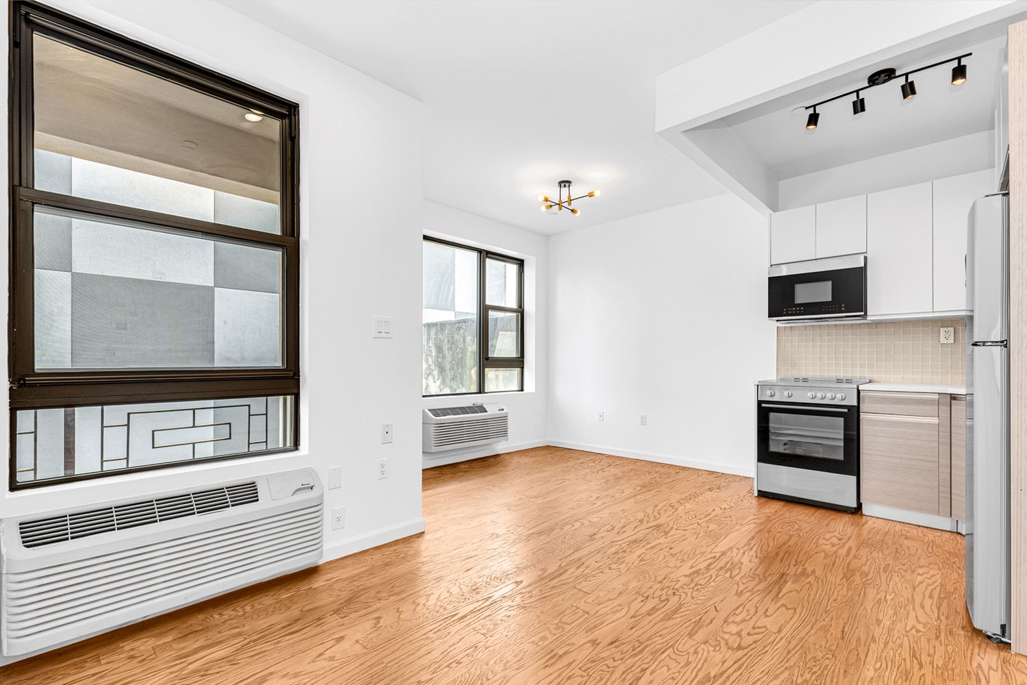 452 Lafayette Avenue, Unit 4B Brooklyn, NY 11205 - Photo 4 of 15 a view of an empty room with kitchen and window