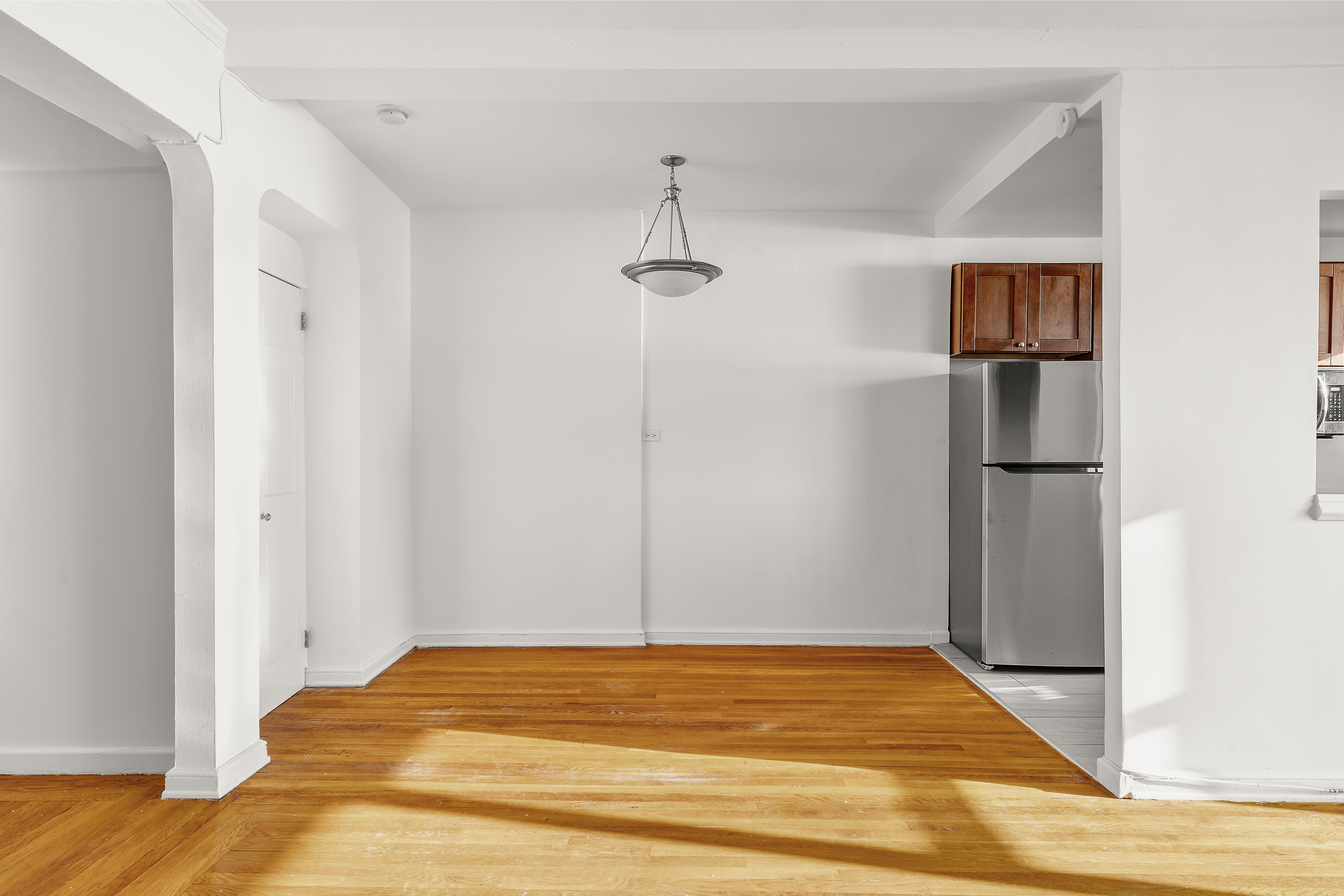 158-18 Riverside Drive West, Unit 4E50 Manhattan, NY 10032 - Photo 4 of 17 a view of a room with wooden floor and ceiling fan