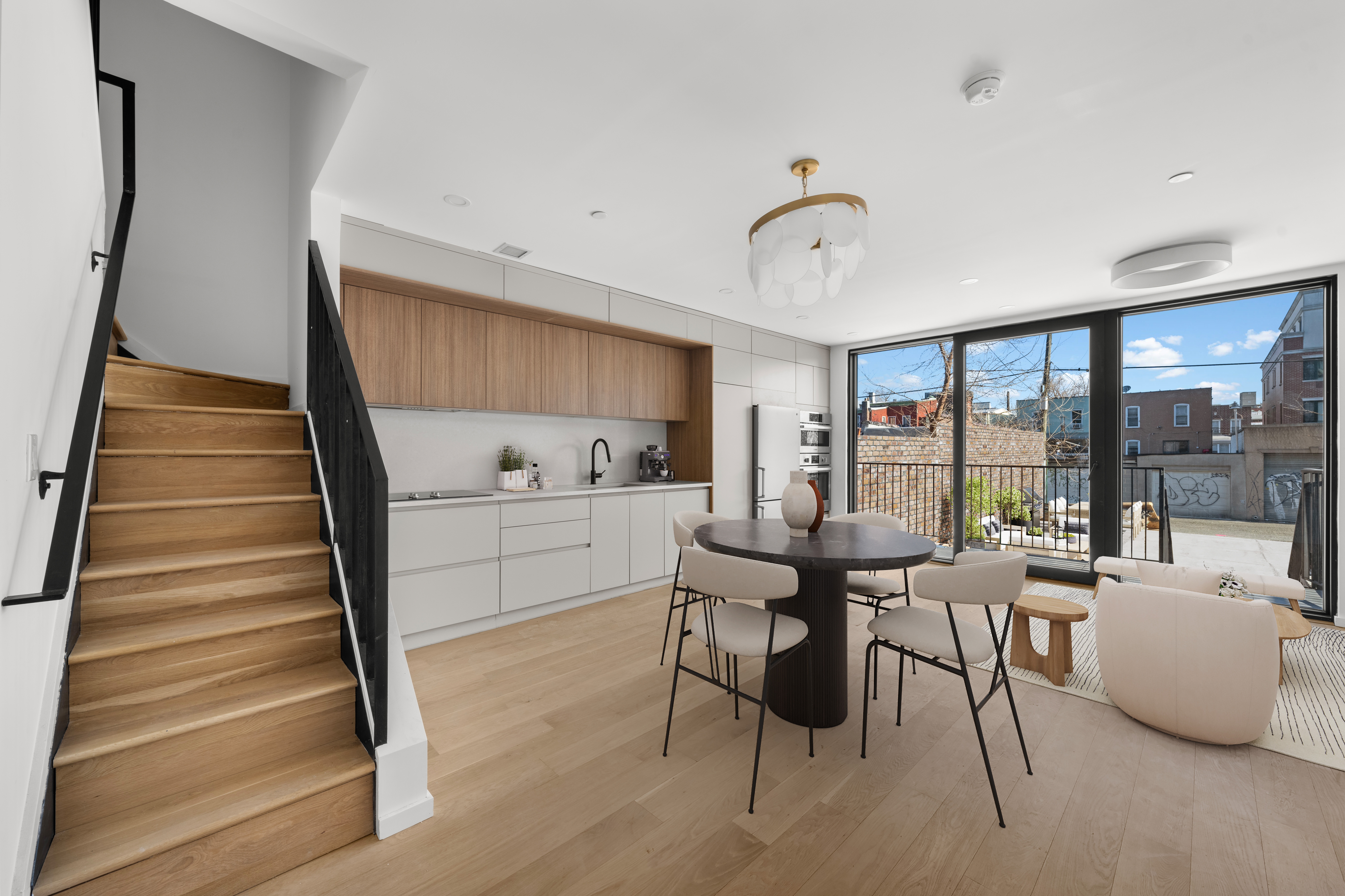 a view of a livingroom with furniture staircase and kitchen view