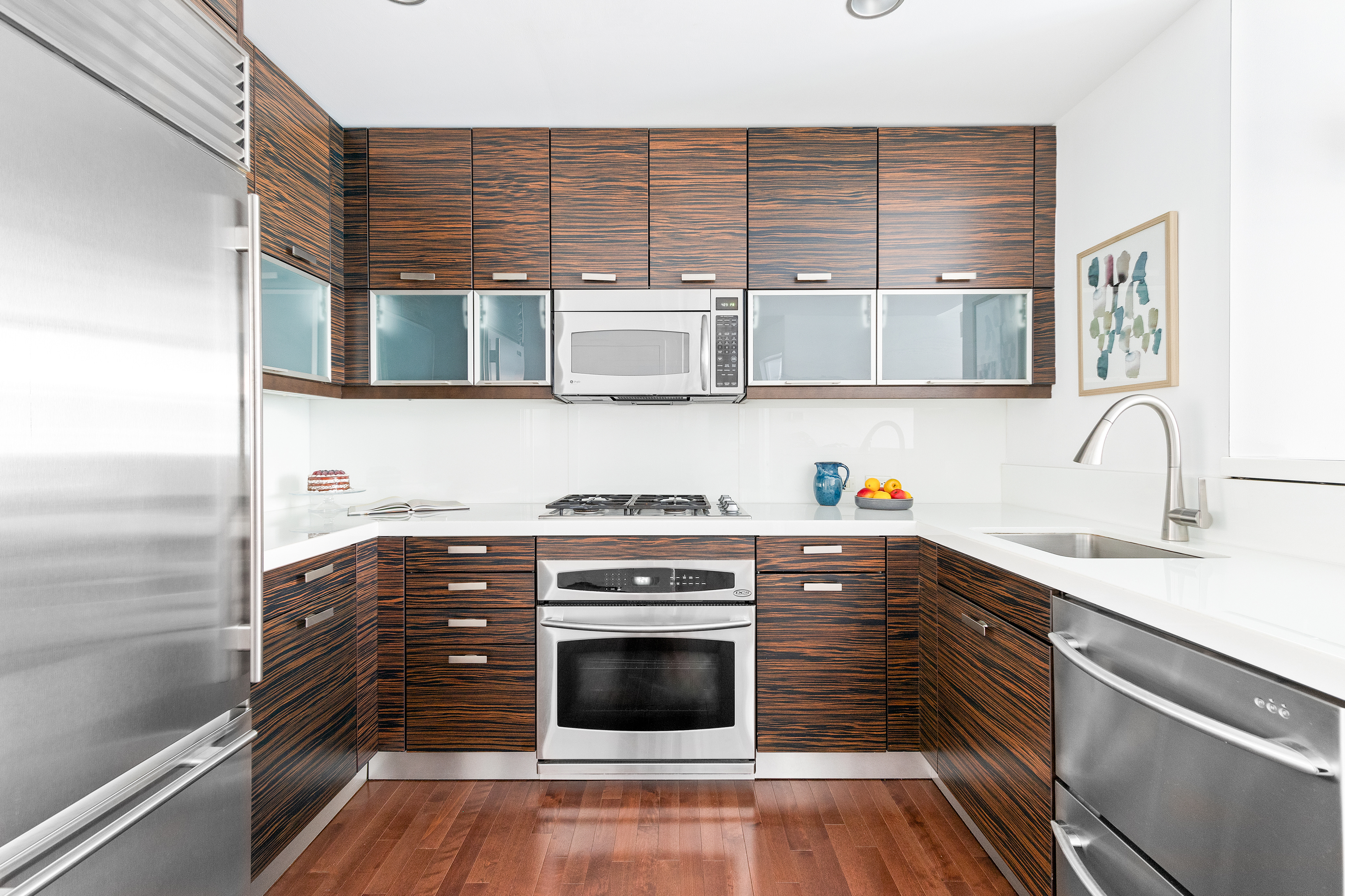 225 East 34th Street, Unit 3H Manhattan, NY 10016 - Photo 5 of 18 a kitchen with stainless steel appliances a stove and a sink