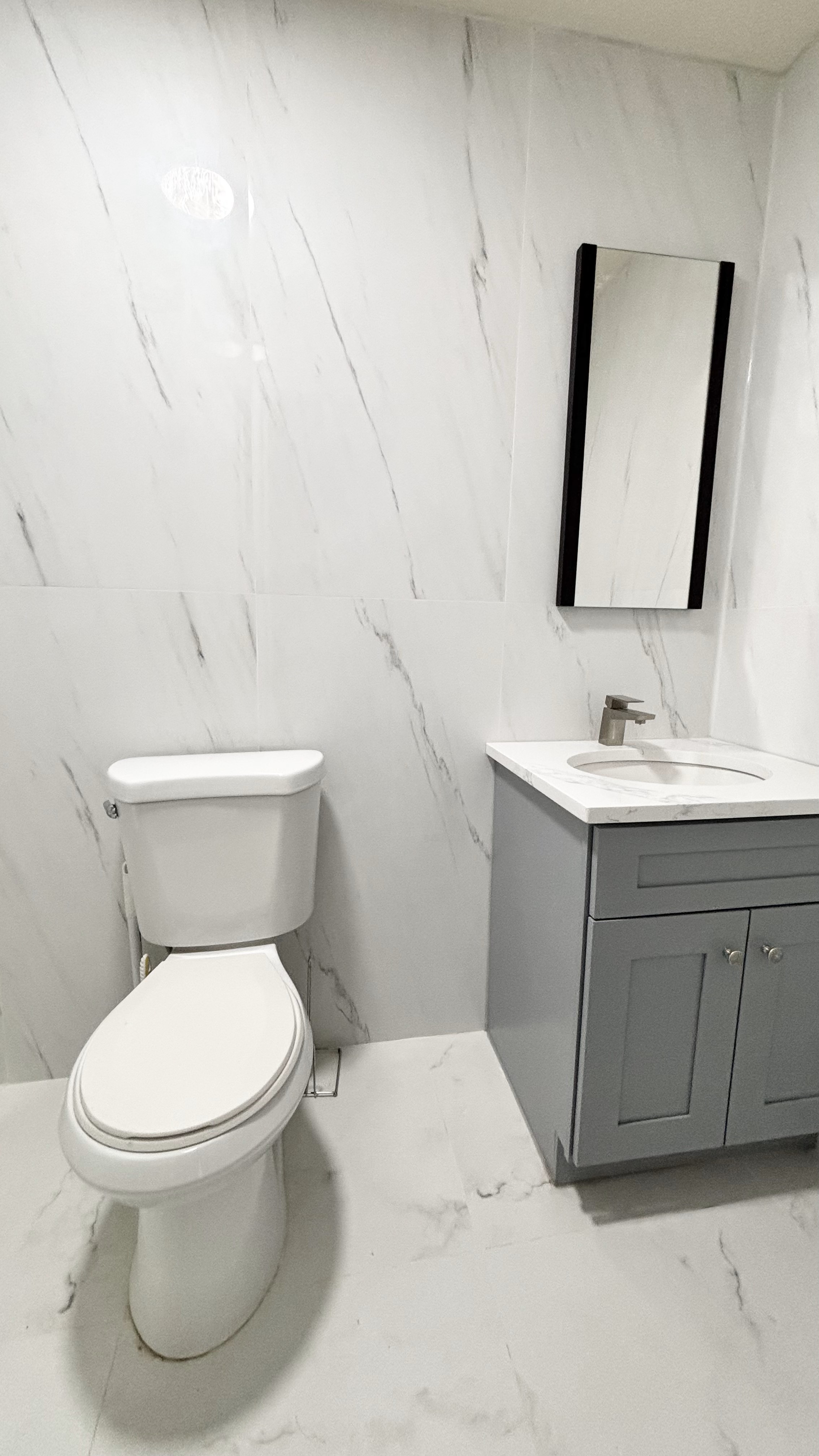 74 Himrod Street, Unit 2 Brooklyn, NY 11221 - Photo 15 of 16 a white toilet sitting next to a bathroom sink