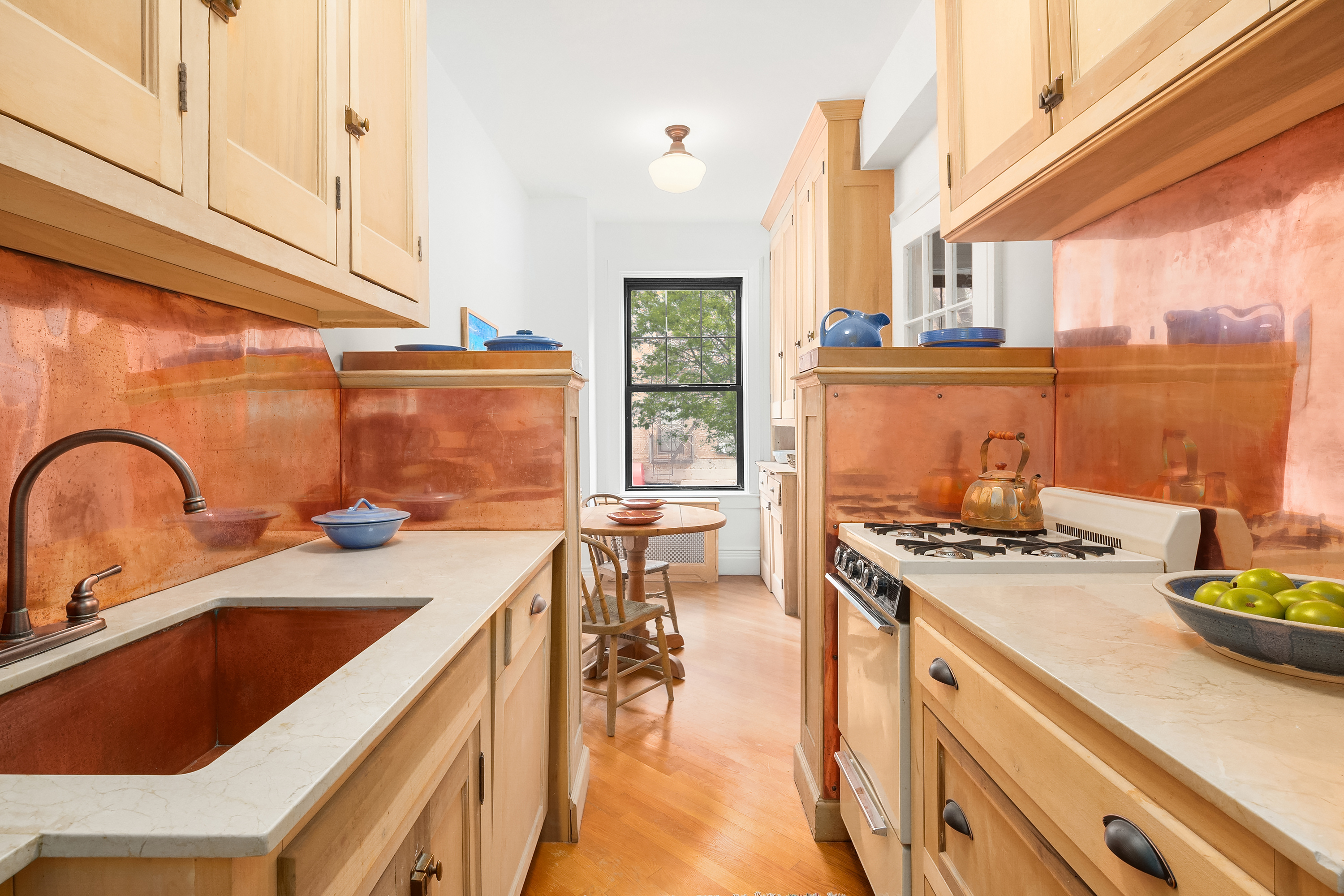 170 2nd Avenue, Unit 2D Manhattan, NY 10003 - Photo 4 of 11 a kitchen with kitchen island a stove a sink and cabinets