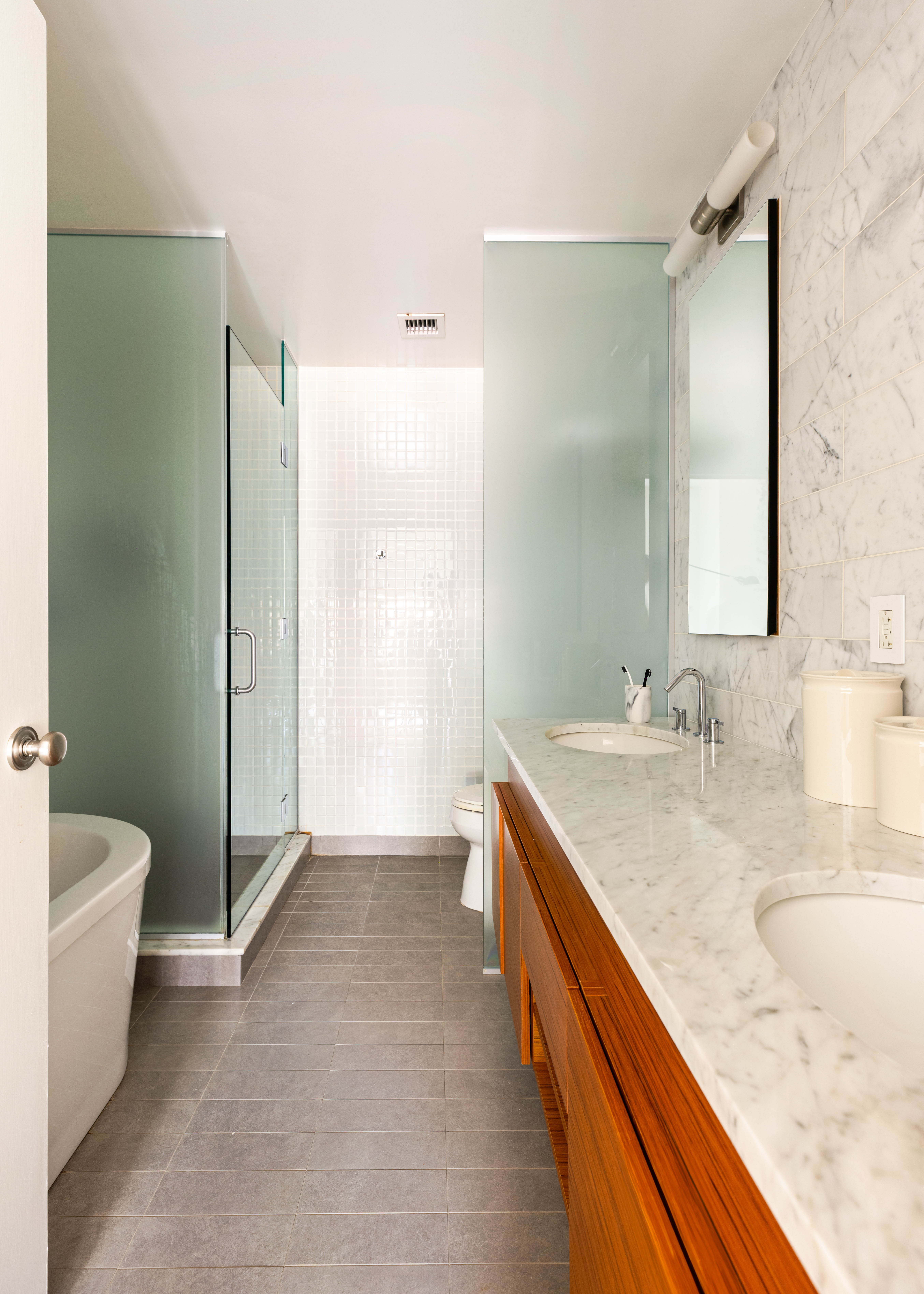 20 Henry Street, Unit 5D/S Brooklyn, NY 11201 - Photo 12 of 15 a spacious bathroom with a granite countertop sink and a mirror