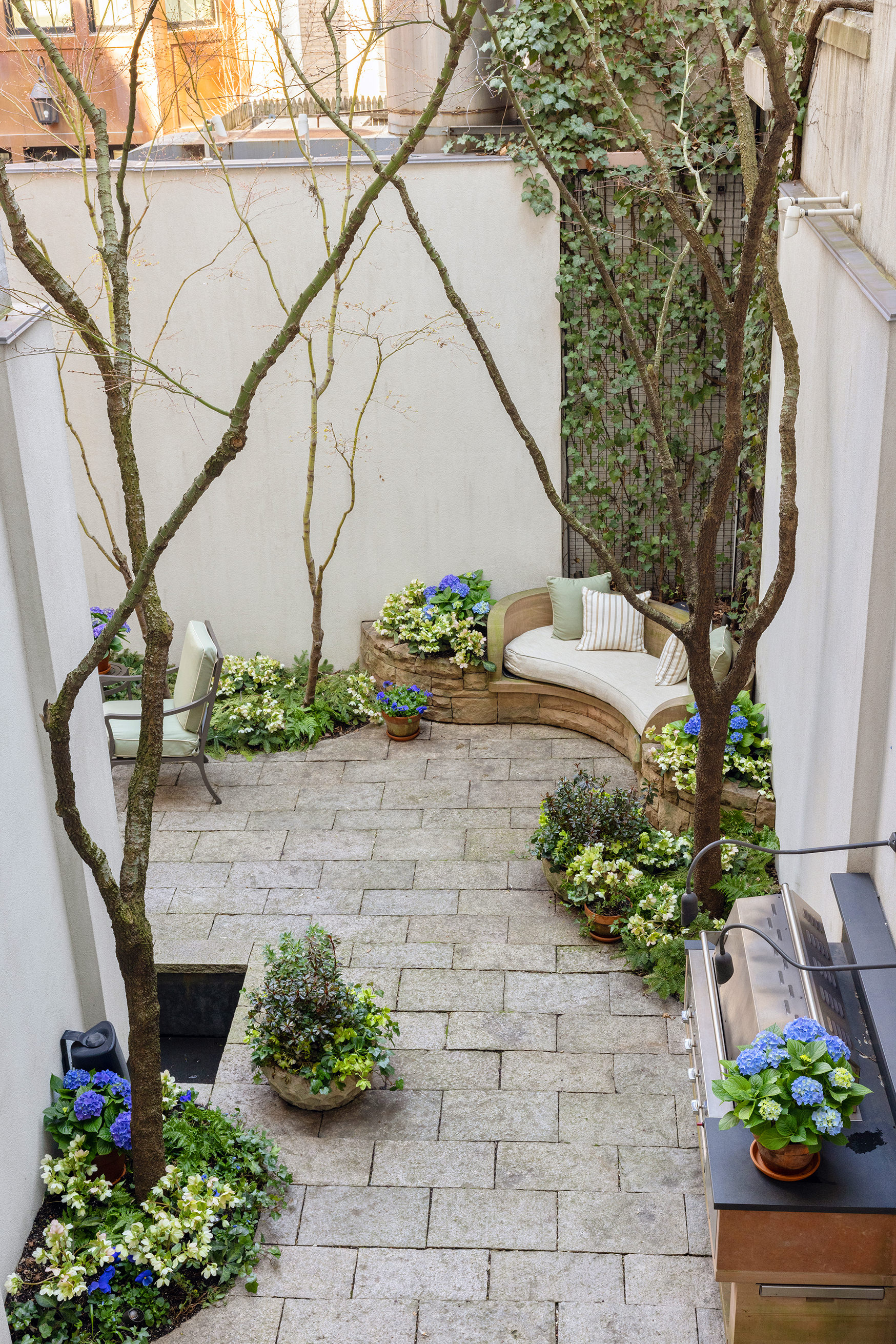 127 East 73rd Street Manhattan, NY 10021 - Photo 27 of 40 a front view of a house with a yard and flowers