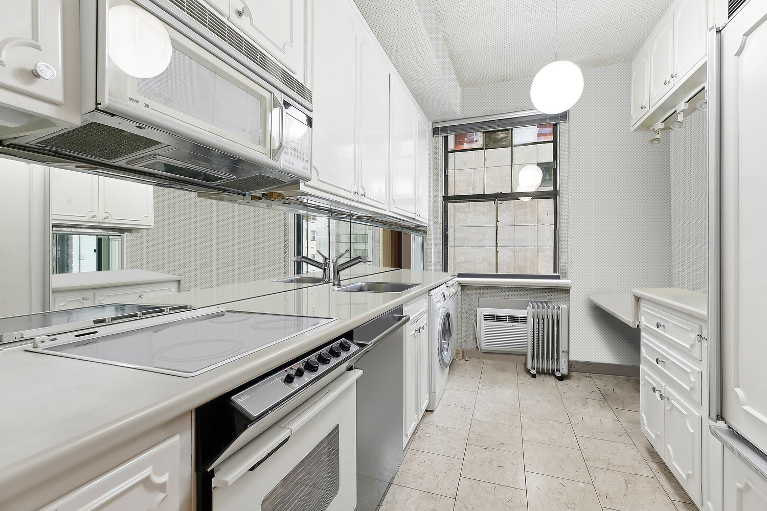 111 East 56th Street, Unit 1005 Manhattan, NY 10022 - Photo 6 of 9 a kitchen that has a sink and a stove
