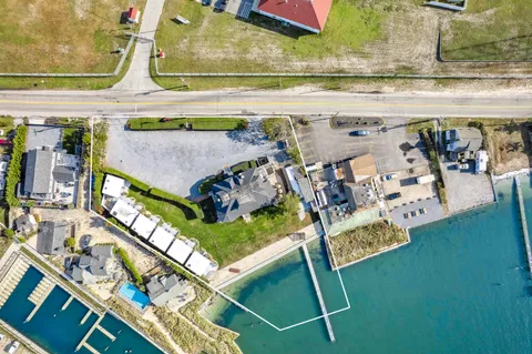 a kitchen with a dining table chairs and white cabinets