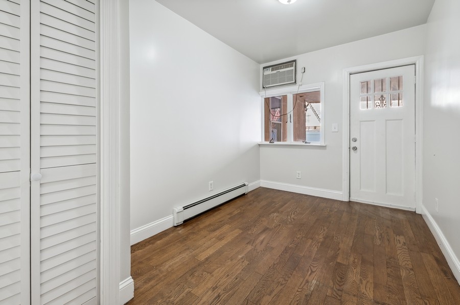 671 Metropolitan Avenue, Unit Undisclosed Brooklyn, NY 11211 - Photo 8 of 13 an empty room with wooden floor and windows