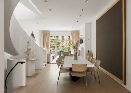 a dining room with furniture and wooden floor