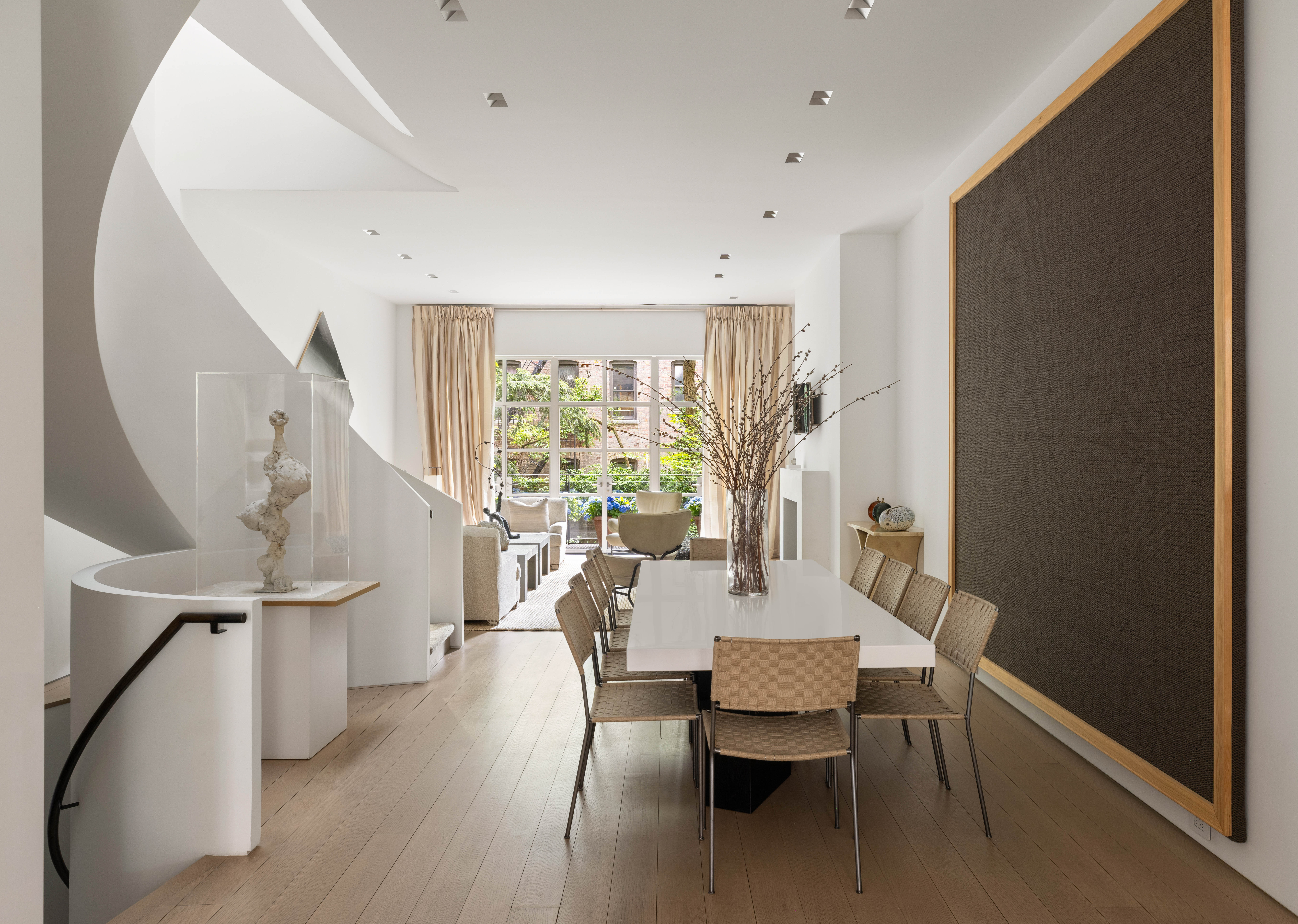 a dining room with furniture and wooden floor