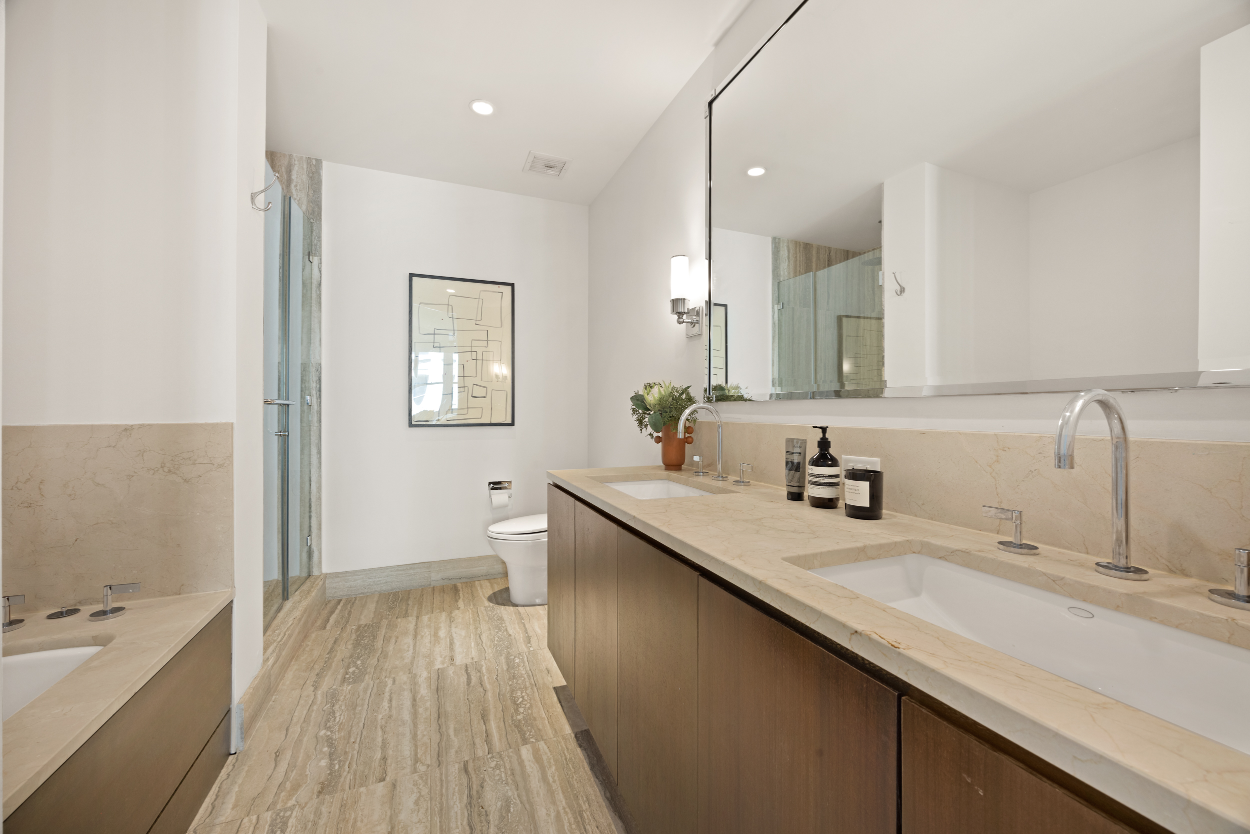 260 Park Avenue South, Unit 9G Manhattan, NY 10010 - Photo 9 of 17 a bathroom with a granite countertop sink a toilet a large mirror and shower