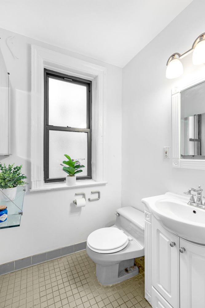 a bathroom with a sink a toilet and a mirror