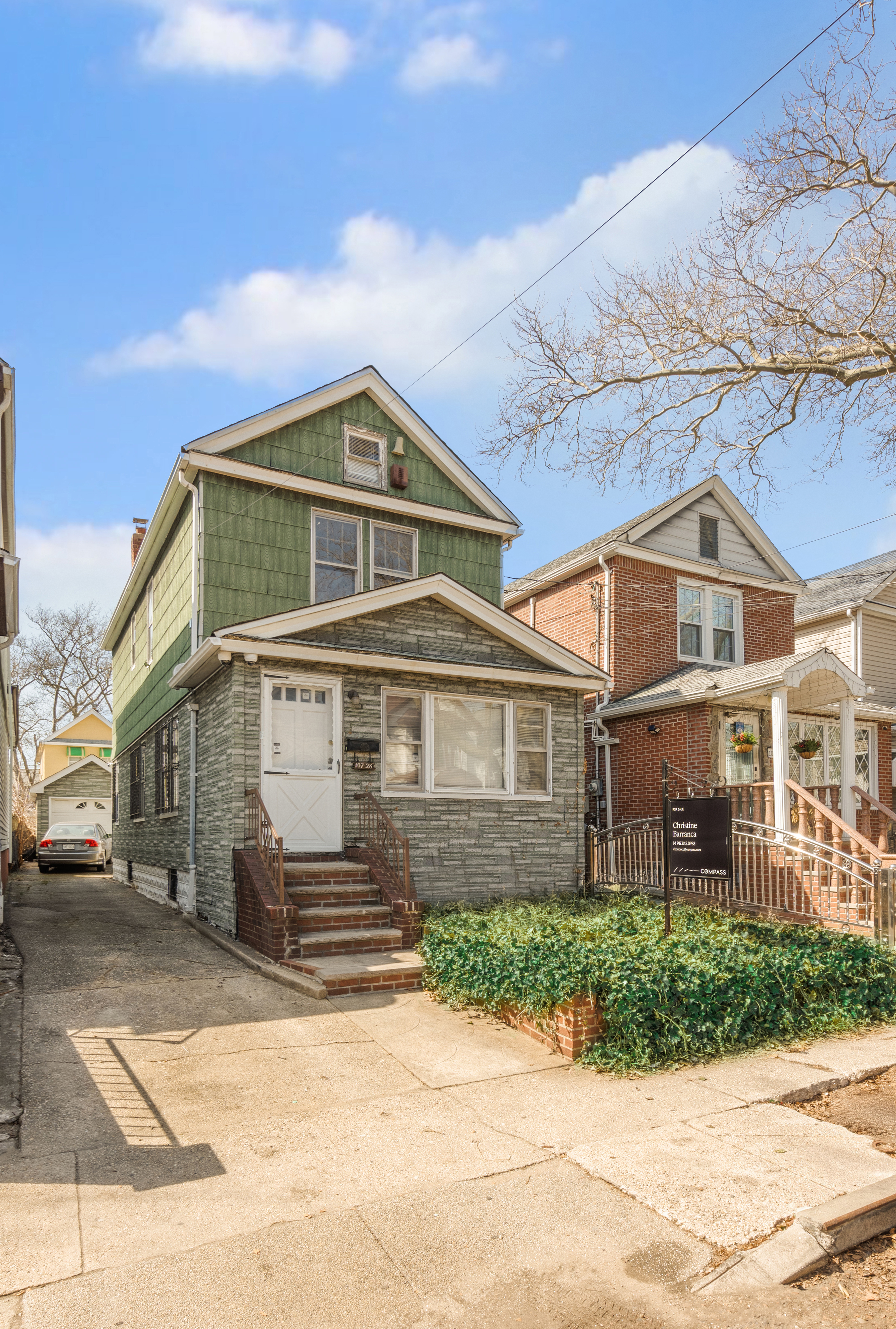 107-28 118th Street Queens, NY 11419 - Photo 10 of 12 a front view of a house with a garden