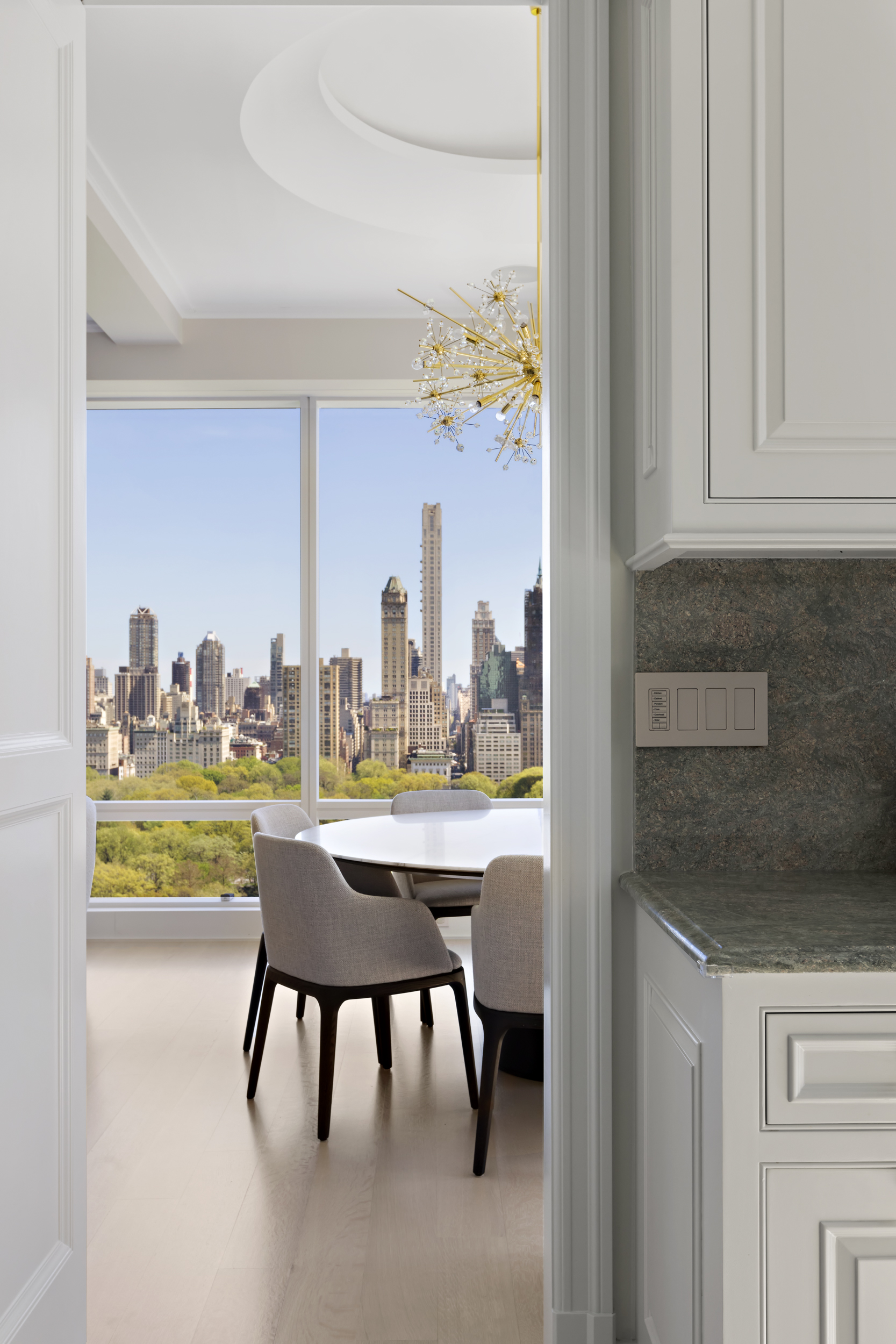 1 Central Park West, Unit 24D Manhattan, NY 10023 - Photo 8 of 19 a kitchen with a table and chairs in it
