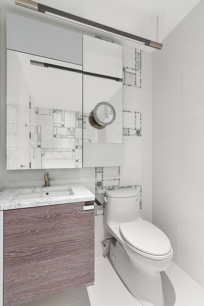 1 City Point, Unit 36D Brooklyn, NY 11201 - Photo 4 of 16 a bathroom with a granite countertop sink a toilet and shower