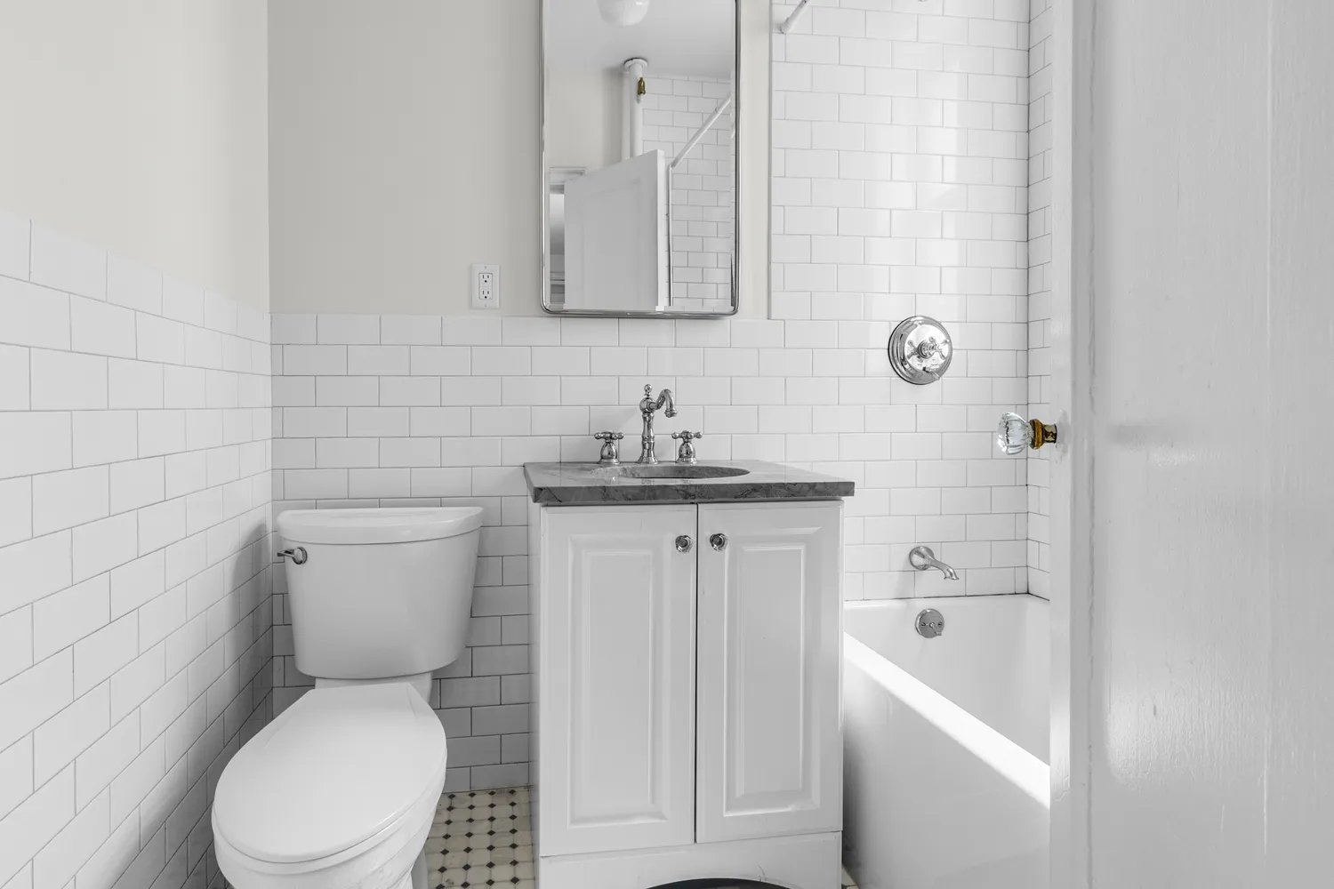 a white toilet sitting next to a bathroom sink