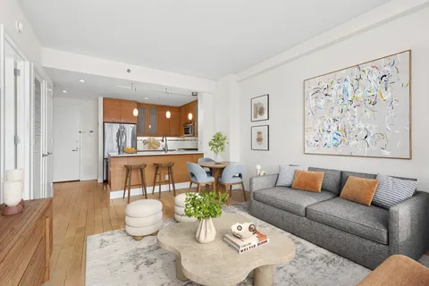 a living room with furniture and a painting on the wall