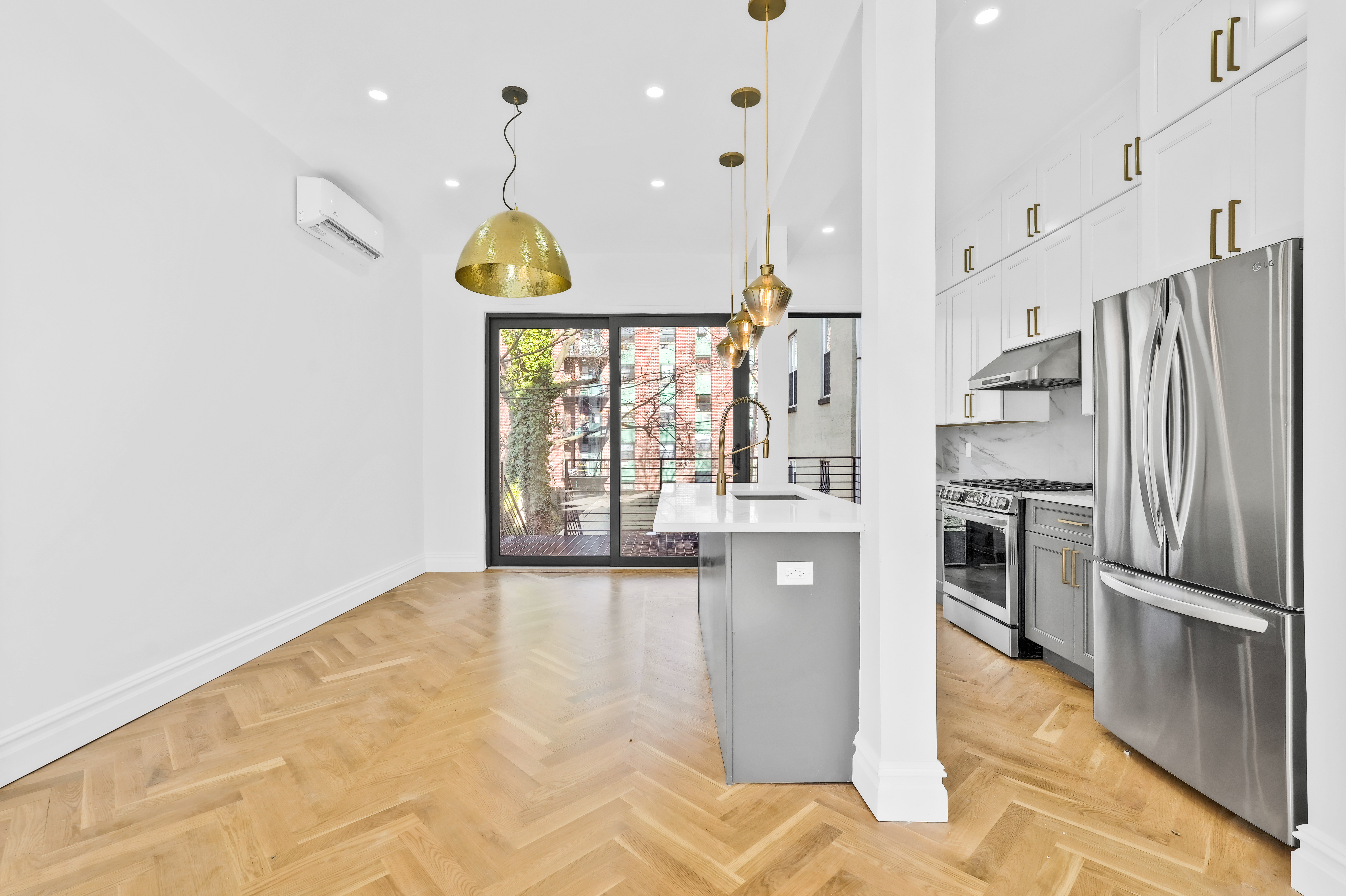 473 Monroe Street Brooklyn, NY 11221 - Photo 9 of 40 a kitchen with stainless steel appliances granite countertop a refrigerator a stove and a wooden floors